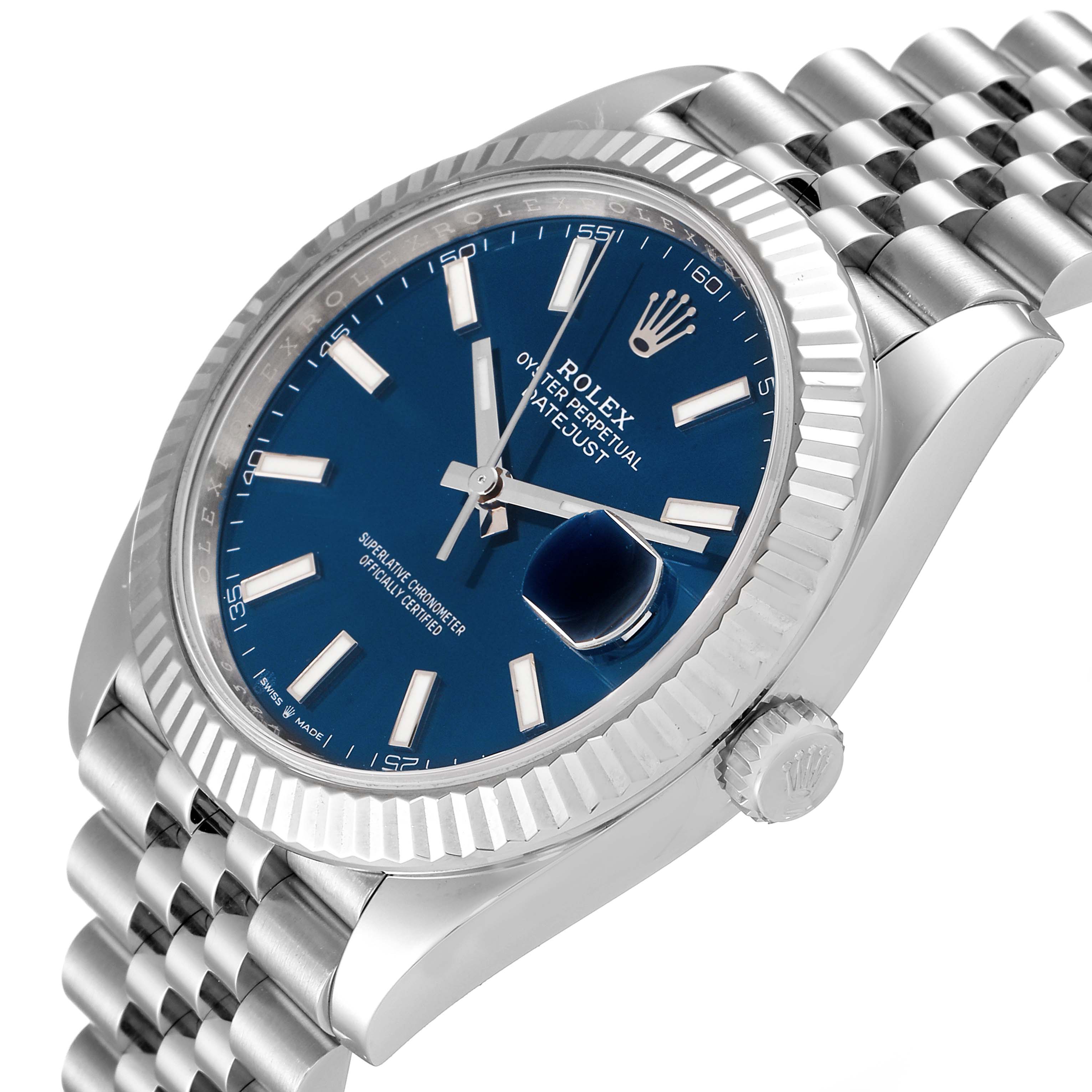 The image shows a close-up of the Rolex Datejust 41 126334 Men
s Stainless Steel Blue Dial 126334 Men
s Stainless Steel Blue Dial watch, showcasing its blue dial, fluted bezel, and part of the jubilee bracelet.
