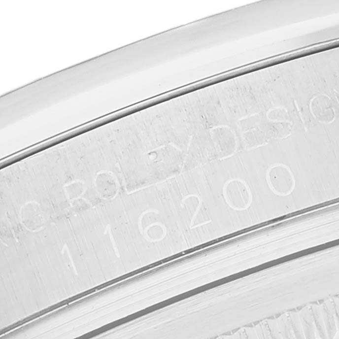 The image shows a close-up of the case back engraving on a Rolex Datejust 116200 Men's Stainless Steel Black Dial 116200 Men's Stainless Steel Black Dial watch, displaying the serial number.