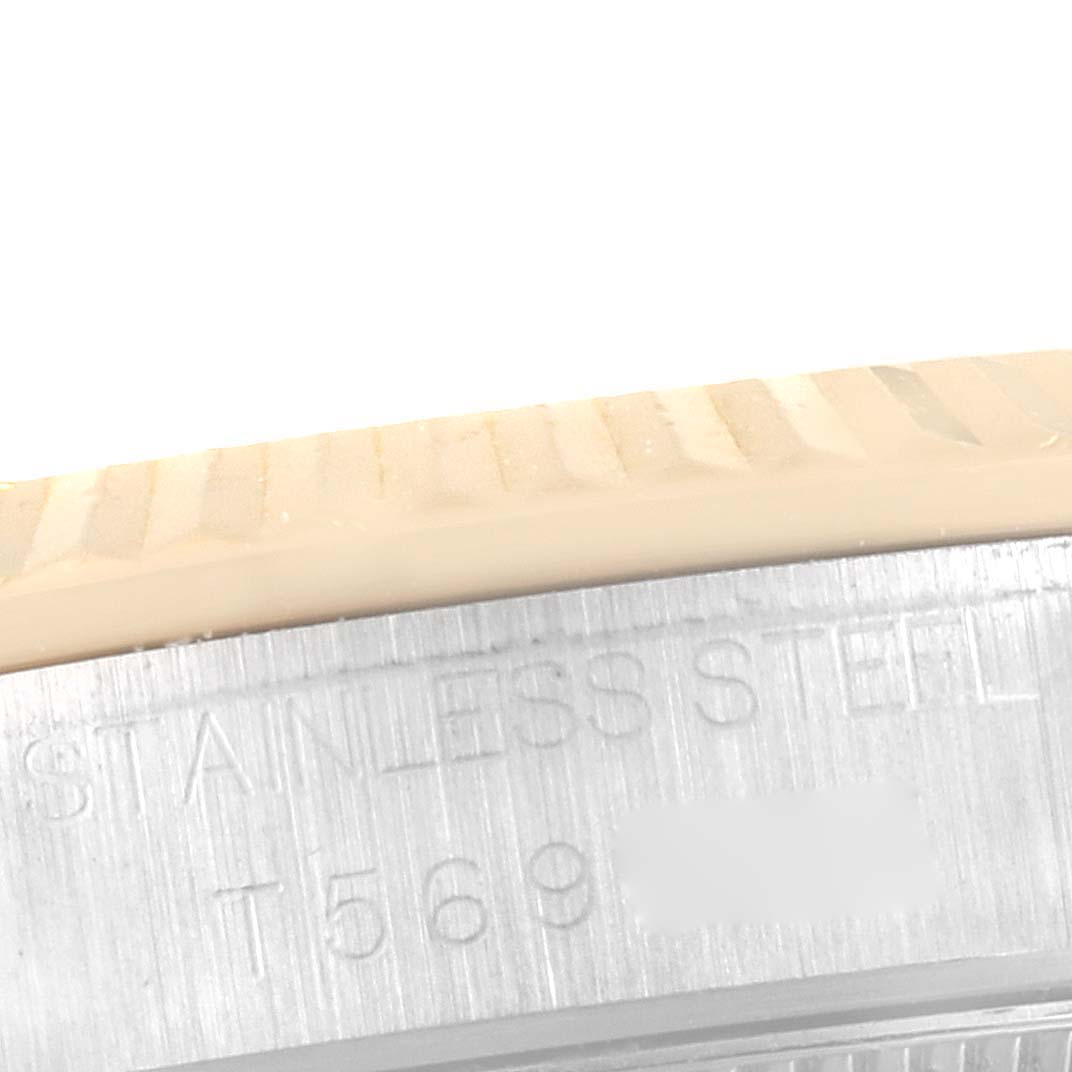 This close-up shows the side of a Mid-Size Rolex watch case with the engraving "STAINLESS STEEL."