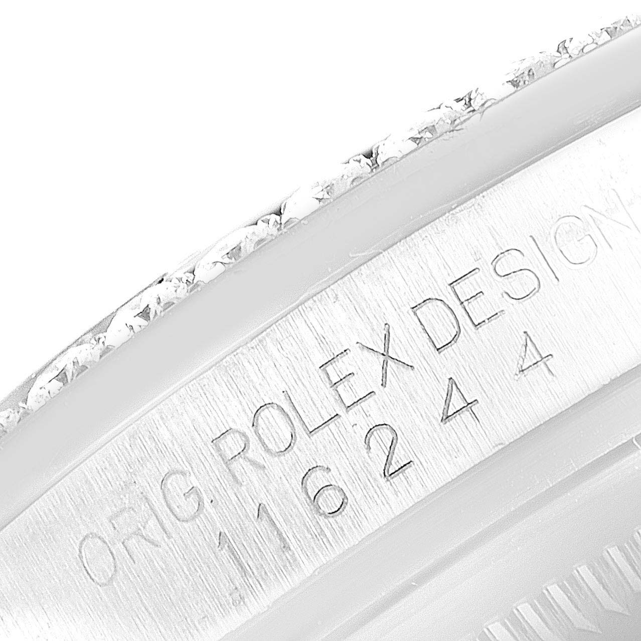 This close-up image shows the engraved serial number on the case side of a Rolex Datejust 116244 Men's Stainless Steel Mother of Pearl Dial 116244 Men's Stainless Steel Mother of Pearl Dial model.