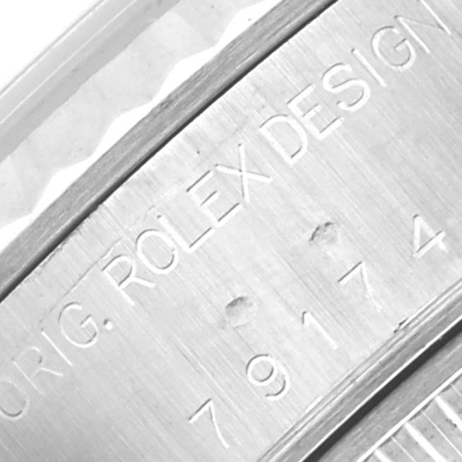 The image shows a close-up of the edge and engraved design number on the casing of a Rolex Datejust 79174 Women's Stainless Steel Mother of Pearl Dial 79174 Women's Stainless Steel Mother of Pearl Dial watch.