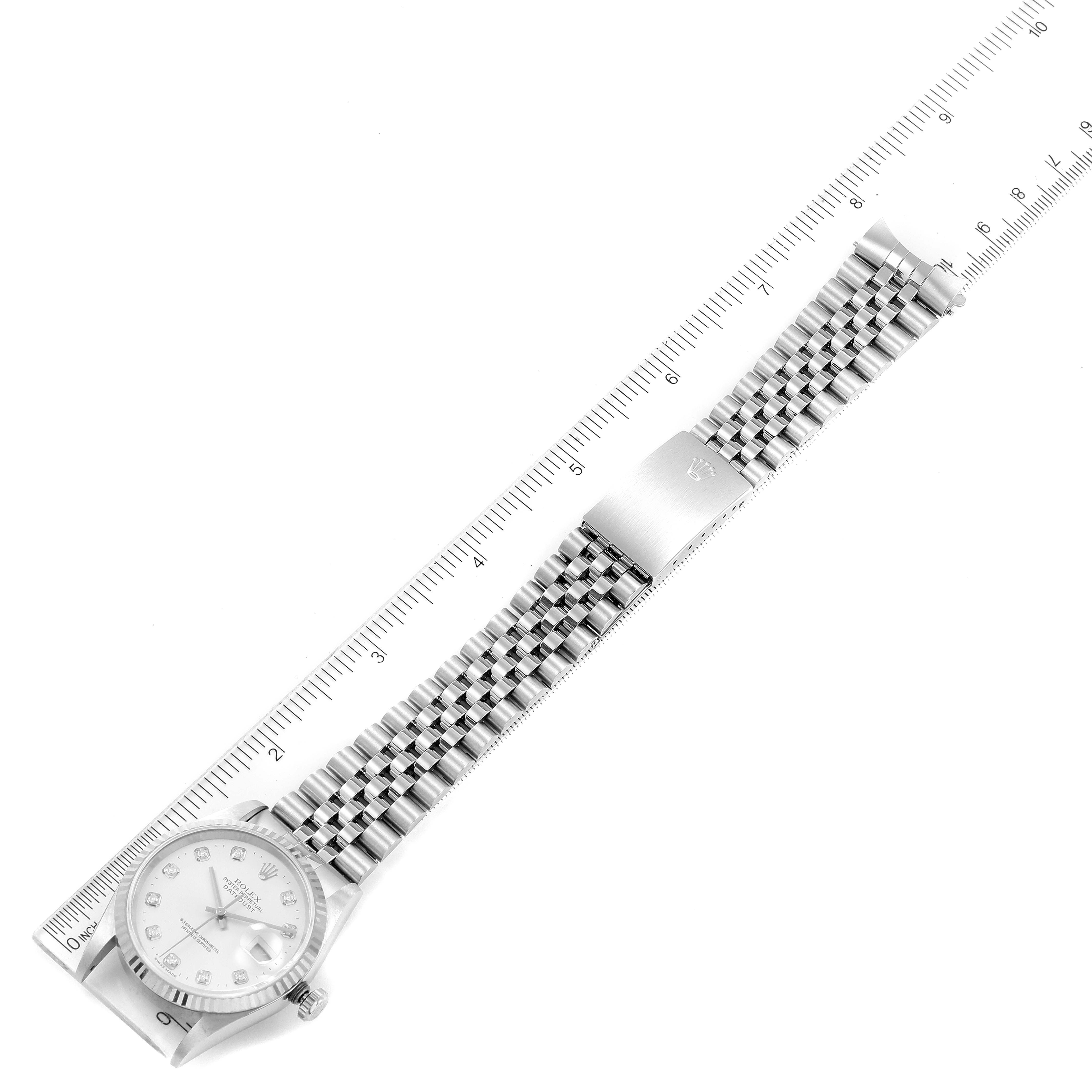 The Rolex Datejust 16234 Men's Stainless Steel Silver Dial 16234 Men's Stainless Steel Silver Dial watch is shown at a top-down angle, with the entire watch and bracelet lying flat next to a ruler.