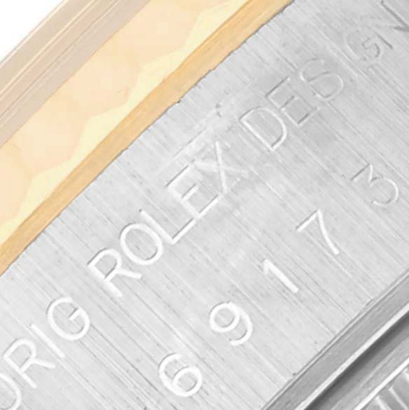 The image shows a close-up of the Rolex Datejust 69173 Women's Steel and Gold (two tone) Black Dial 69173 Women's Steel and Gold (two tone) Black Dial's engraved edge or rehaut, displaying text and numbers.
