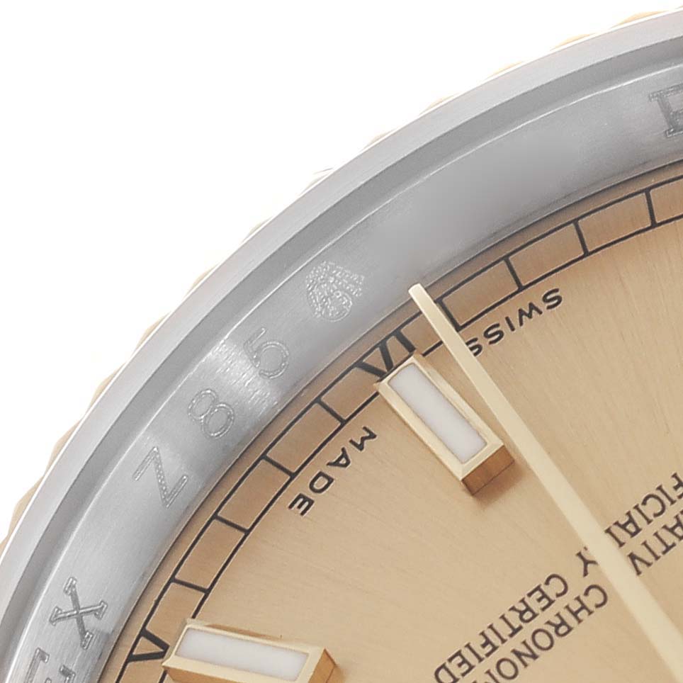 The image shows a close-up angle of the Rolex Datejust 116233 Men
s Steel and Gold (two tone) Champagne Dial 116233 Men
s Steel and Gold (two tone) Champagne Dial
s dial, bezel, and hands.