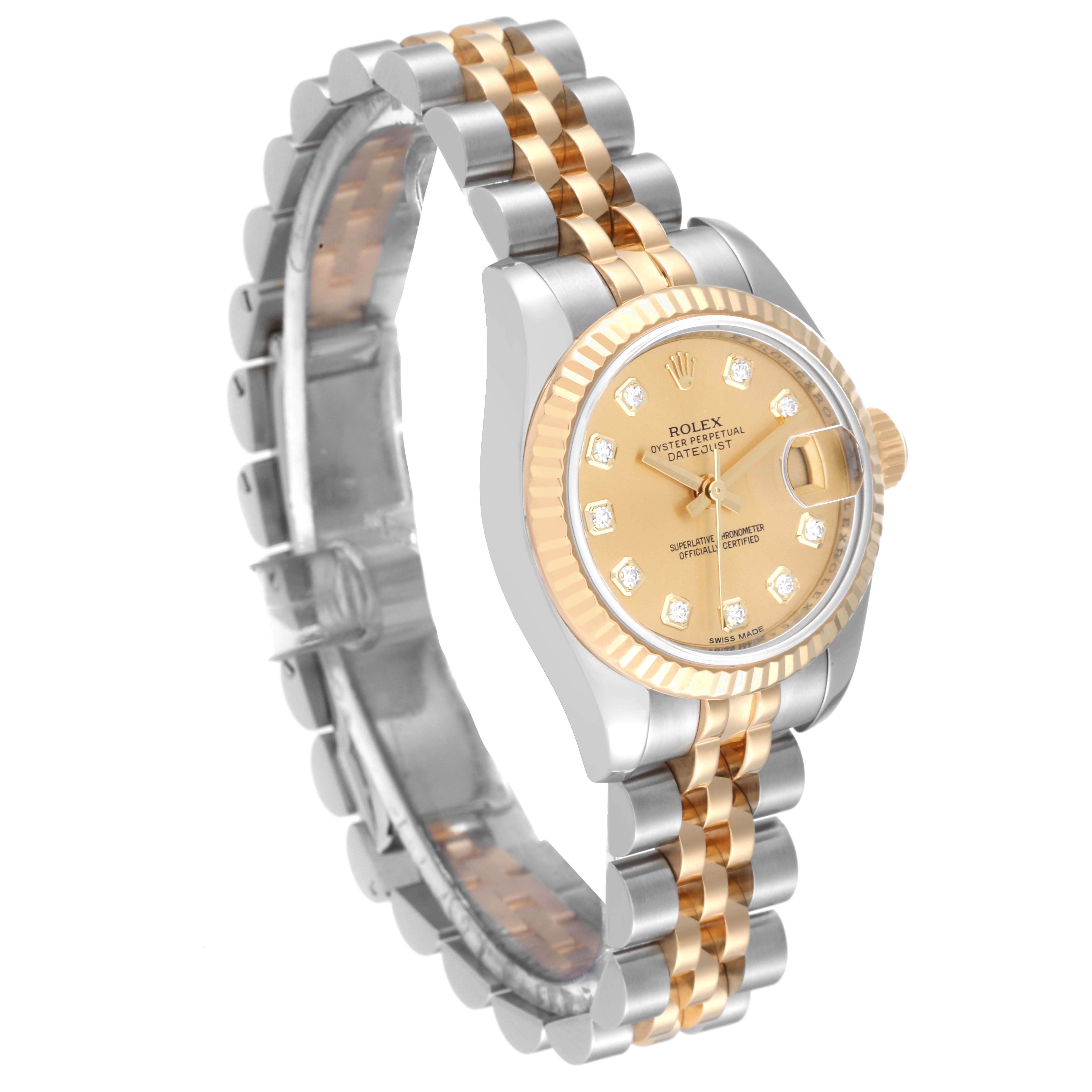 The image shows a Rolex Datejust 179173 Women's Steel and Gold (two tone) Champagne Dial 179173 Women's Steel and Gold (two tone) Champagne Dial watch at an angled view, highlighting its two-tone band and diamond-accented face.
