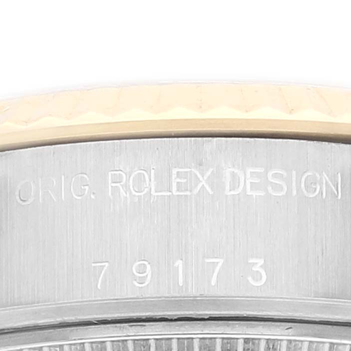 The image shows a close-up of the engraved serial and model numbers on the case side of a Rolex Datejust 79173 Women's Steel and Gold (two tone) Silver Dial 79173 Women's Steel and Gold (two tone) Silver Dial watch.
