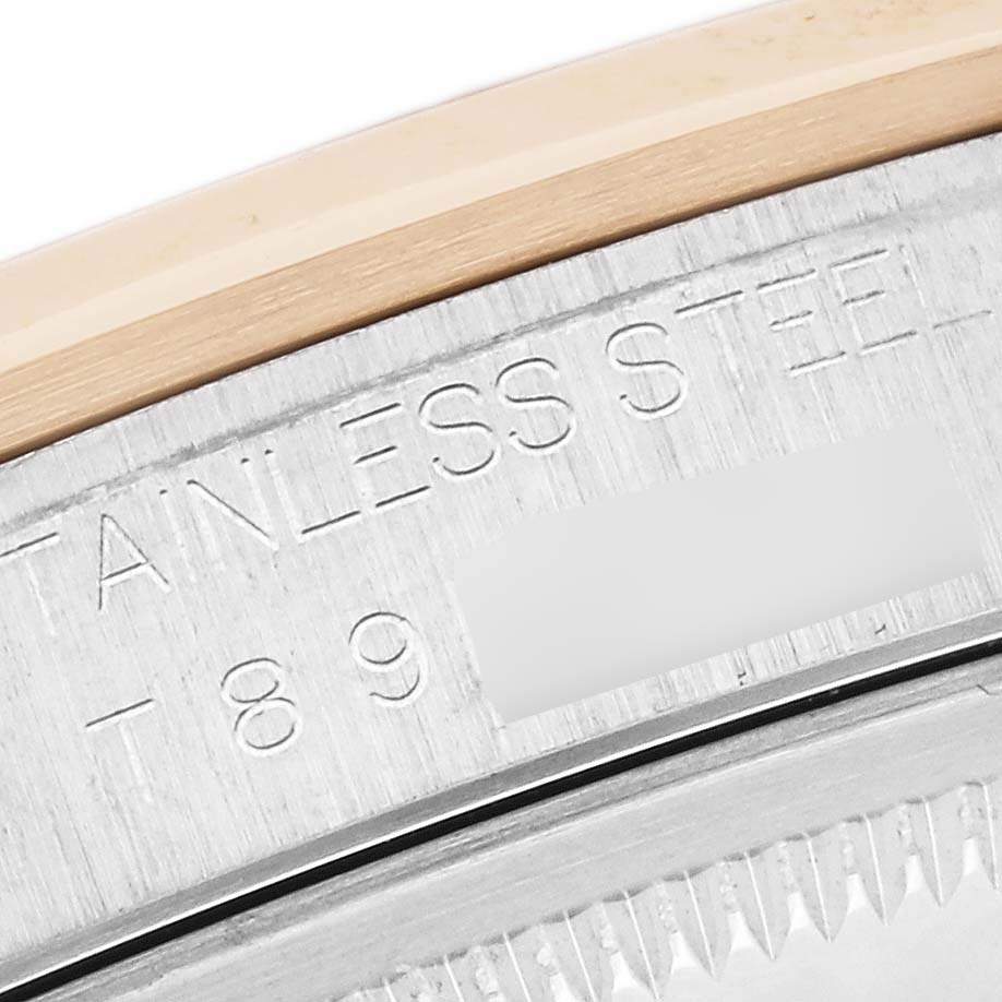 The image shows the side view of a Rolex Datejust 16203 Men's Steel and Gold (two tone) Grey Dial 16203 Men's Steel and Gold (two tone) Grey Dial, highlighting the edge of the case with engraved text.