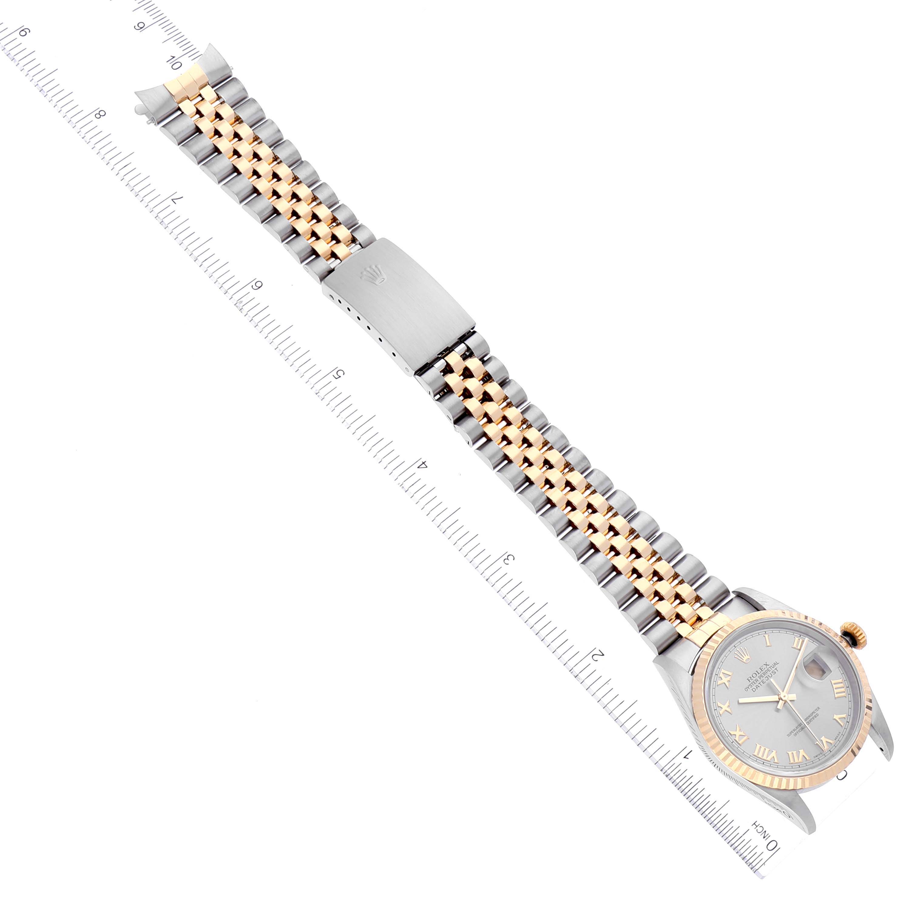The image shows an overhead view of the Rolex Datejust 16233 Men
s Steel and Gold (two tone) Grey Dial 16233 Men
s Steel and Gold (two tone) Grey Dial watch, displaying the face, band, and clasp, alongside a measuring ruler.
