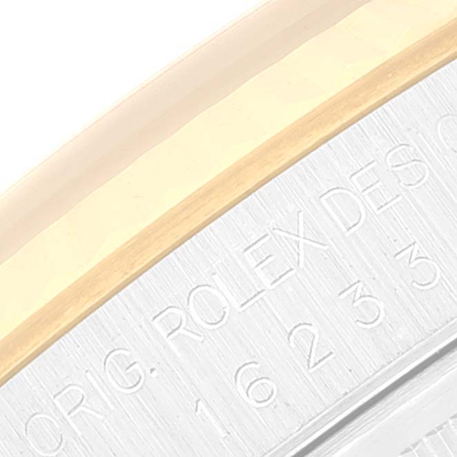This image shows a close-up of the case edge with engravings on a Rolex Datejust 16233 Men
s Steel and Gold (two tone) Grey Dial 16233 Men
s Steel and Gold (two tone) Grey Dial watch.