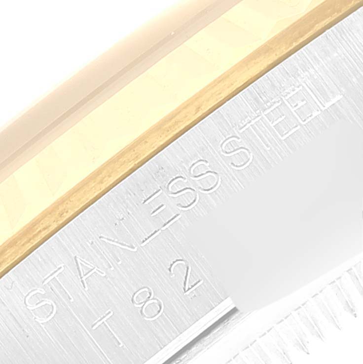 The image shows an engraved "STAINLESS STEEL" labeling on the side of a Rolex Datejust 16233 Men
s Steel and Gold (two tone) Grey Dial 16233 Men
s Steel and Gold (two tone) Grey Dial watch case.