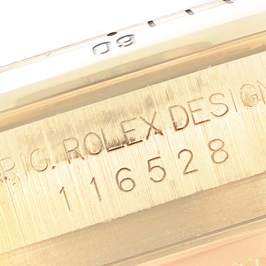 This close-up image shows the engraved serial and model number on the side of a Rolex Daytona 116528 Men's Yellow Gold Champagne Dial 116528 Men's Yellow Gold Champagne Dial watch.