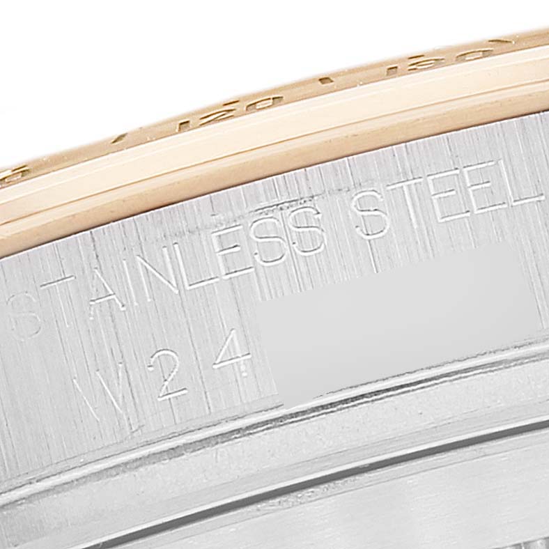 This image shows a close-up of the engravings and the outer edge of a Rolex Daytona 16523 Men's Steel and Gold (two tone) Black Dial 16523 Men's Steel and Gold (two tone) Black Dial watch bezel.