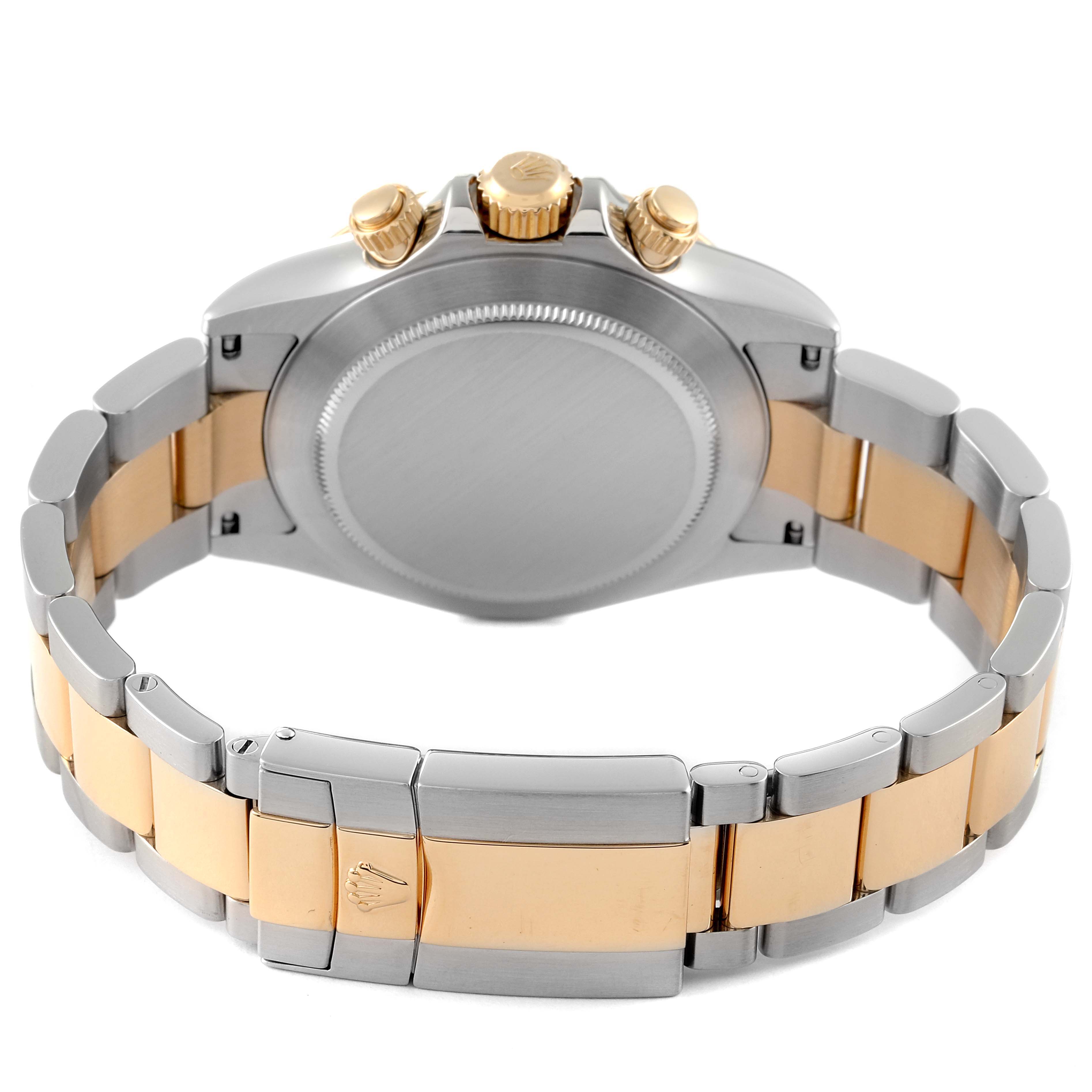 The image shows the back view of a Rolex Daytona 116523 Men's Steel and Gold (two tone) Mother of Pearl Dial 116523 Men's Steel and Gold (two tone) Mother of Pearl Dial watch, highlighting its bracelet and clasp, along with the chronograph pushers.