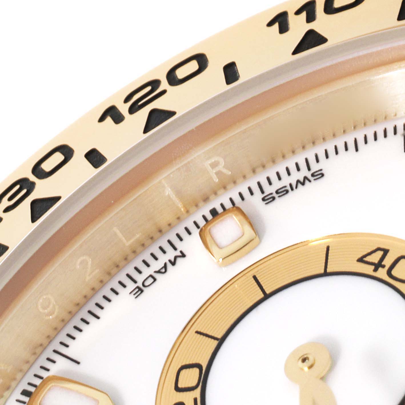 The image shows a close-up of the bezel and part of the dial of a Rolex Daytona 116508 Men's Yellow Gold White Dial 116508 Men's Yellow Gold White Dial watch, highlighting the tachymeter scale.