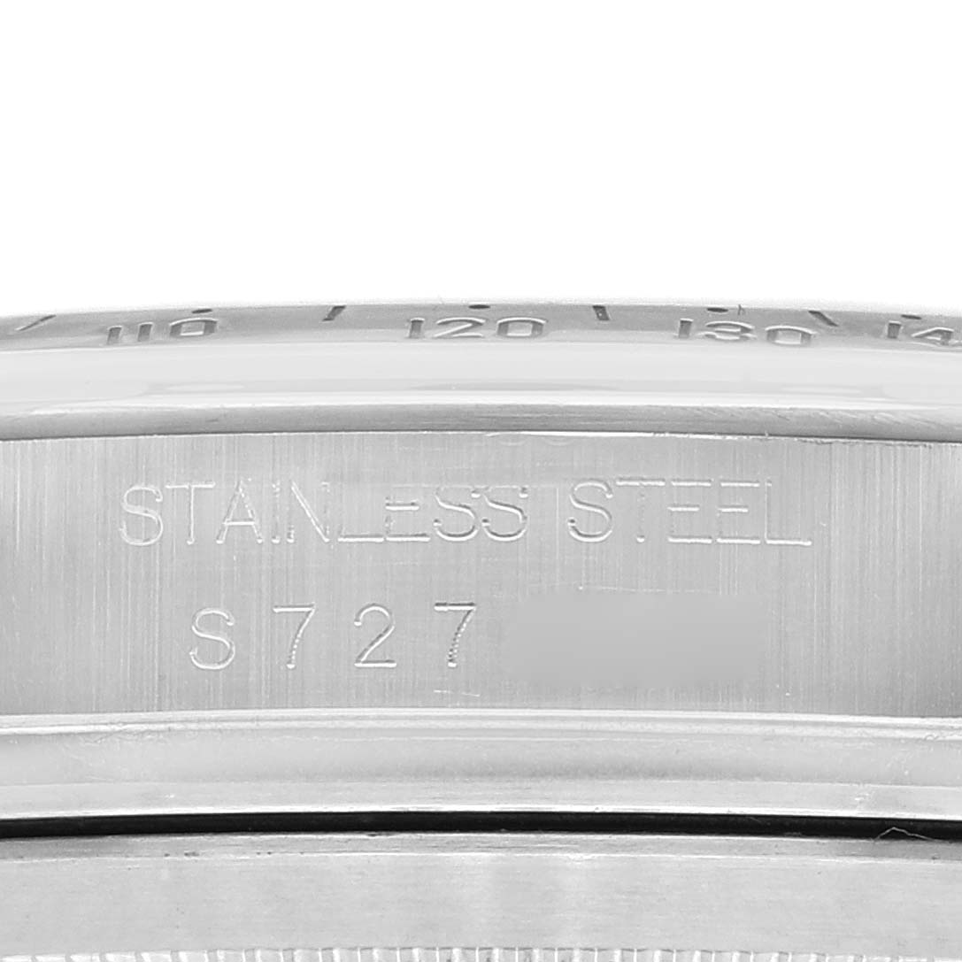 The image shows a close-up of the side of a Rolex Daytona 16520 Men
s Stainless Steel White Dial 16520 Men
s Stainless Steel White Dial model, featuring the stainless steel engraving and part of the bezel.