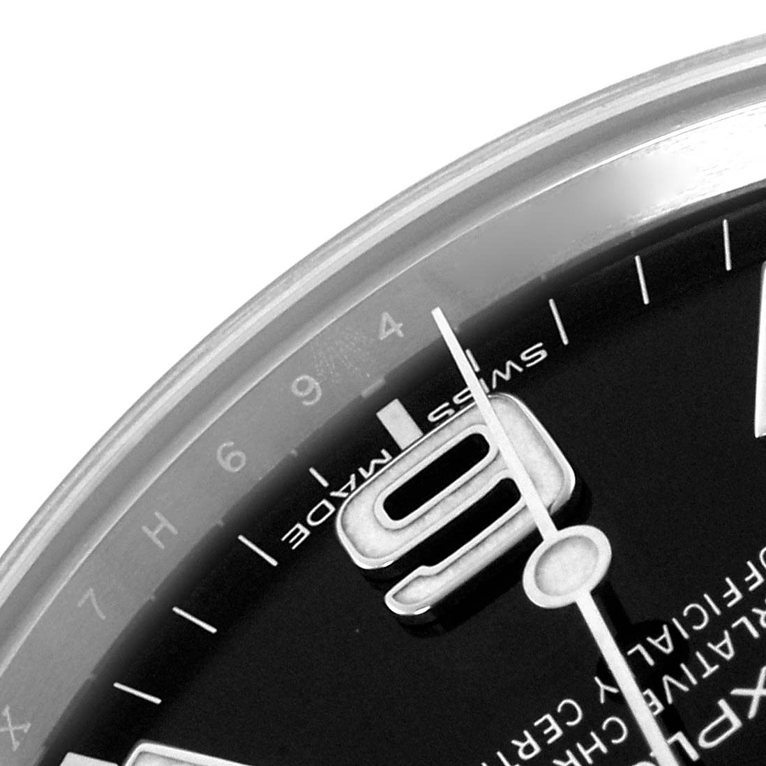 The image shows a close-up of the Rolex Explorer 214270 Men
s Stainless Steel Black Dial 214270 Men
s Stainless Steel Black Dial watch
s dial, specifically the numeral 9 and “Swiss Made” marking.
