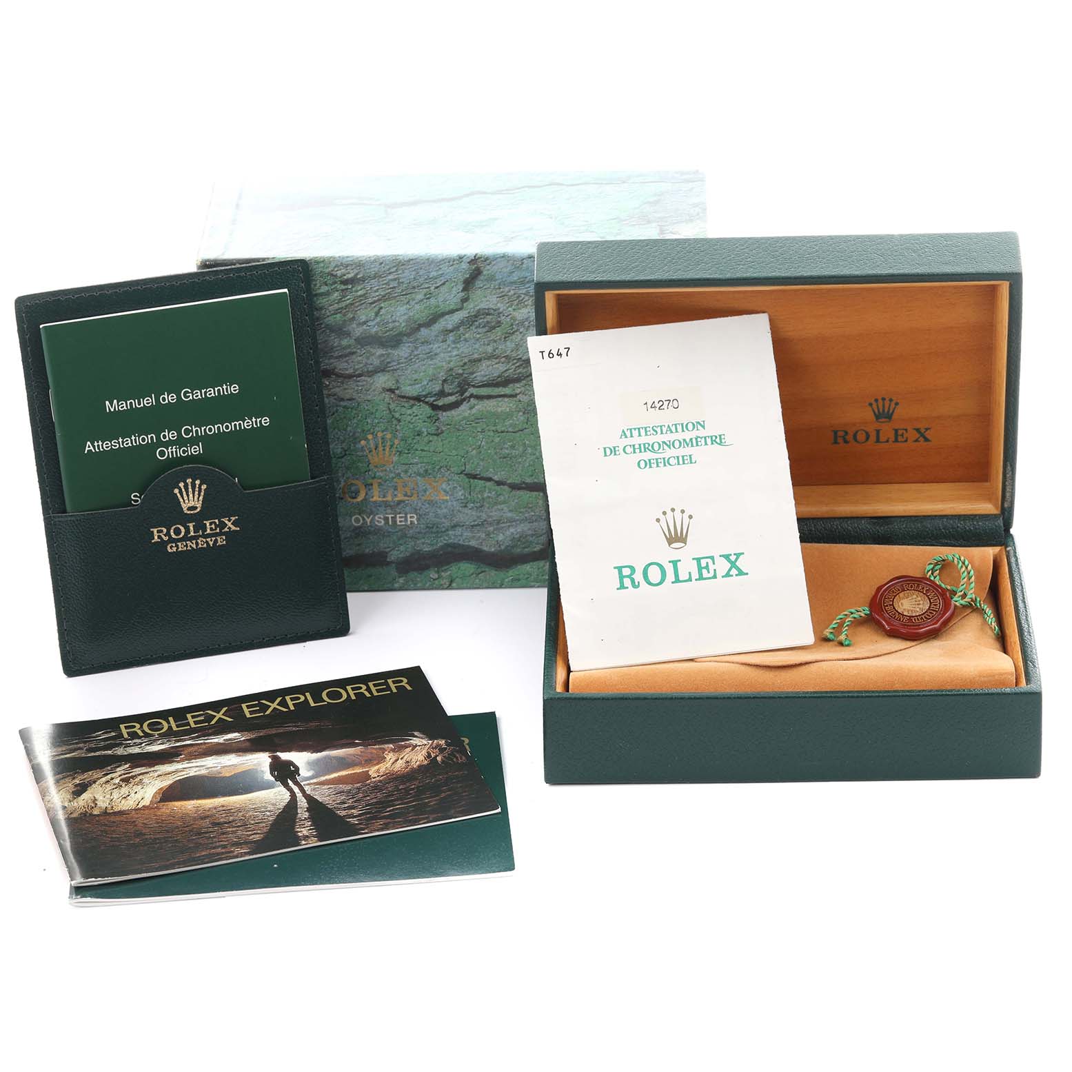 The image shows accessories for a Rolex Explorer 14270 Men
s Stainless Steel Black Dial 14270 Men
s Stainless Steel Black Dial, including manuals, warranty, and the watch box, viewed from above.