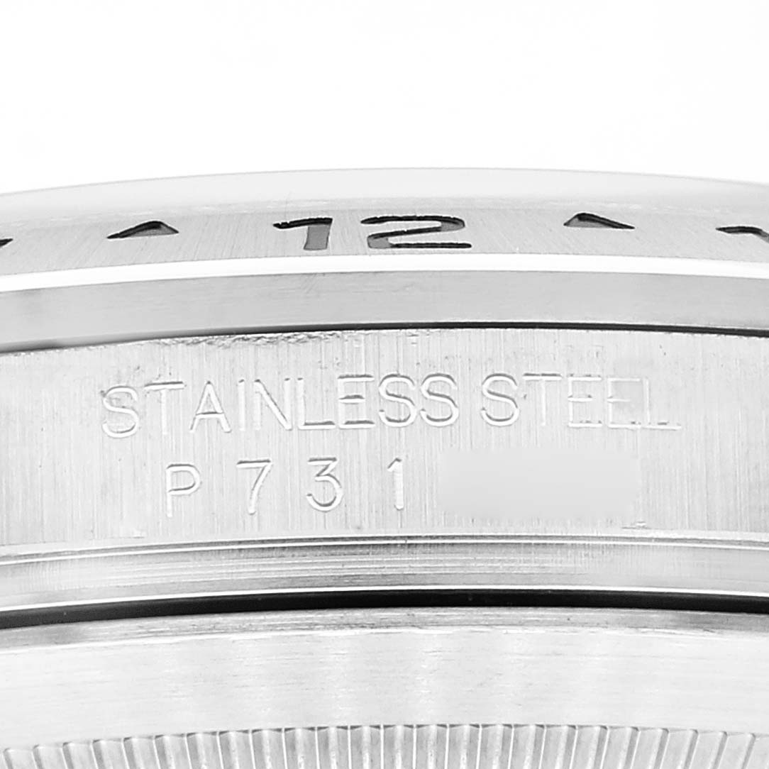 This image shows a close-up of the stainless steel bezel and part of the casing with engravings for the Rolex Explorer 16570 Men
s Stainless Steel Black Dial 16570 Men
s Stainless Steel Black Dial watch.