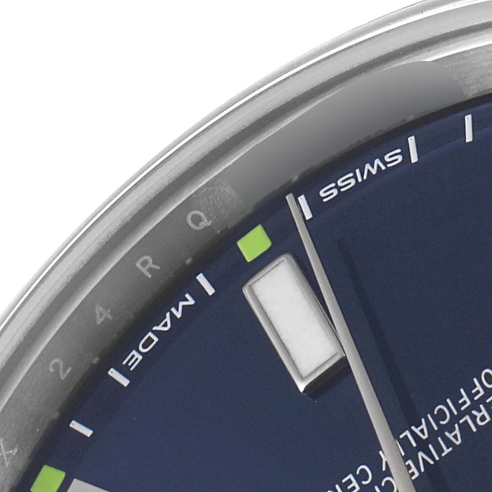 The image shows a close-up of the dial and bezel edge of a Rolex Oyster Perpetual 114300 Men
s Stainless Steel Blue Dial 114300 Men
s Stainless Steel Blue Dial watch.