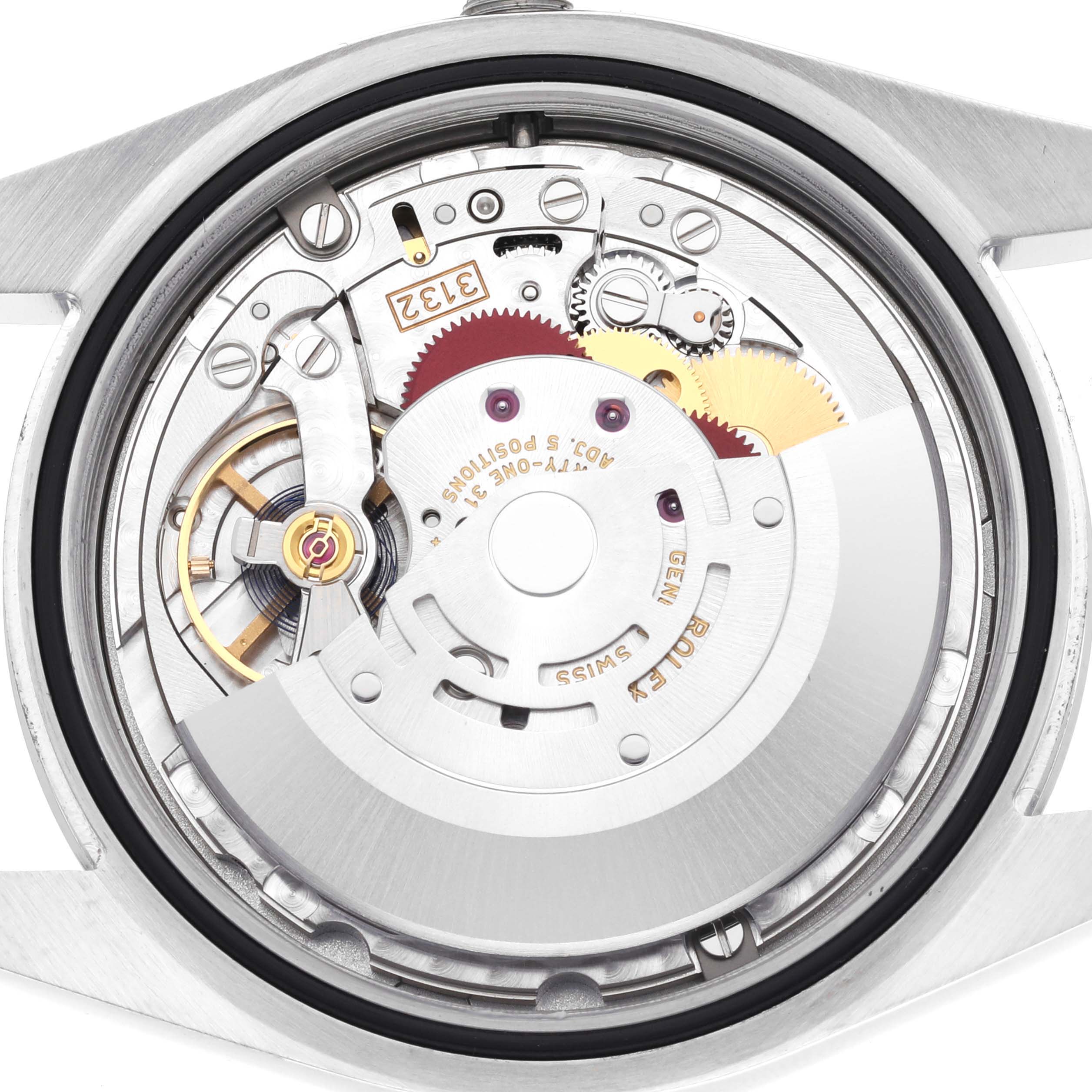 The image shows a close-up of the movement and internal mechanism of the Rolex Oyster Perpetual 114300 Men's Stainless Steel Blue Dial 114300 Men's Stainless Steel Blue Dial watch.