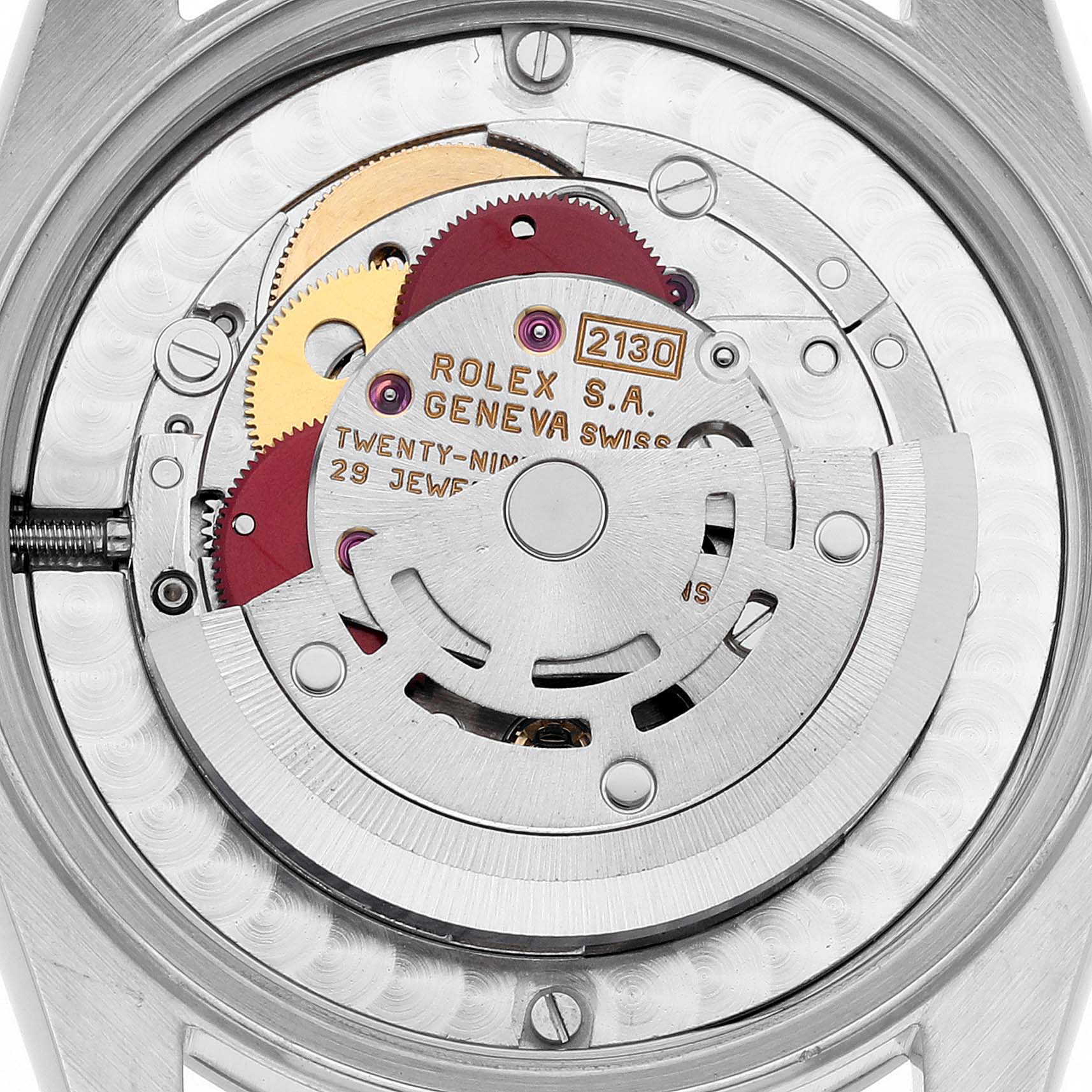The image shows a close-up of the movement inside a Rolex Mid-Size 67480 Women's Stainless Steel Pink Dial 67480 Women's Stainless Steel Pink Dial watch, highlighting gears and metal parts.