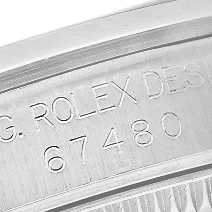 The image shows an engraved serial number and "Rolex Design" on the inner rim of a Rolex Mid-Size 67480 Women's Stainless Steel Pink Dial 67480 Women's Stainless Steel Pink Dial watch case.
