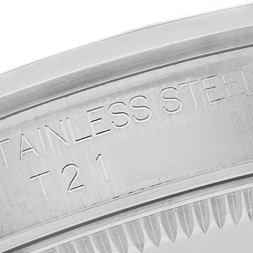 The image shows a close-up of the Rolex Mid-Size 67480 Women's Stainless Steel Pink Dial 67480 Women's Stainless Steel Pink Dial model's stainless steel watch case with engraved details.