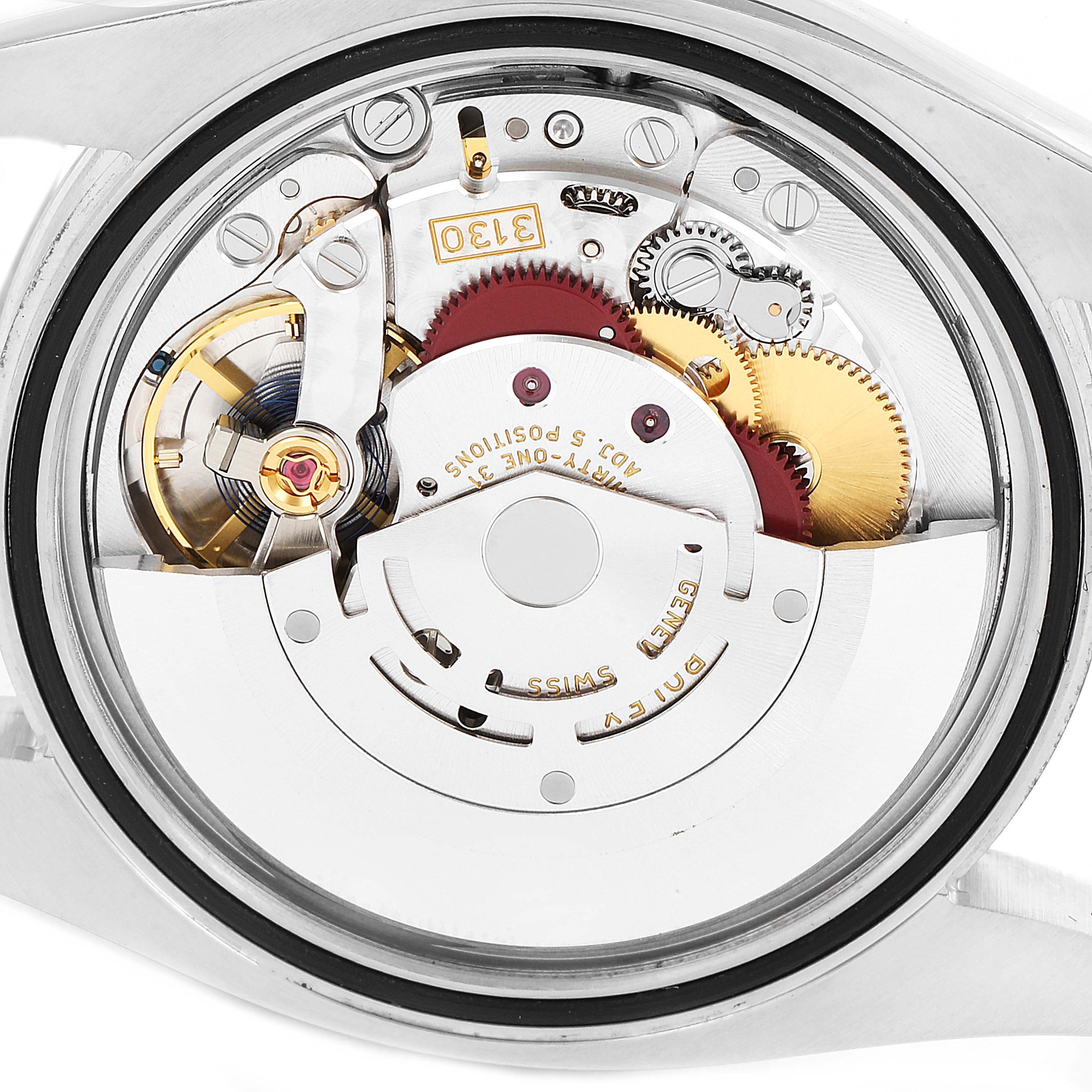 The image shows the internal mechanism of a Rolex Oyster Perpetual 116000 Men's Stainless Steel Grey Dial 116000 Men's Stainless Steel Grey Dial watch, focusing on the movement and gears from a back angle.