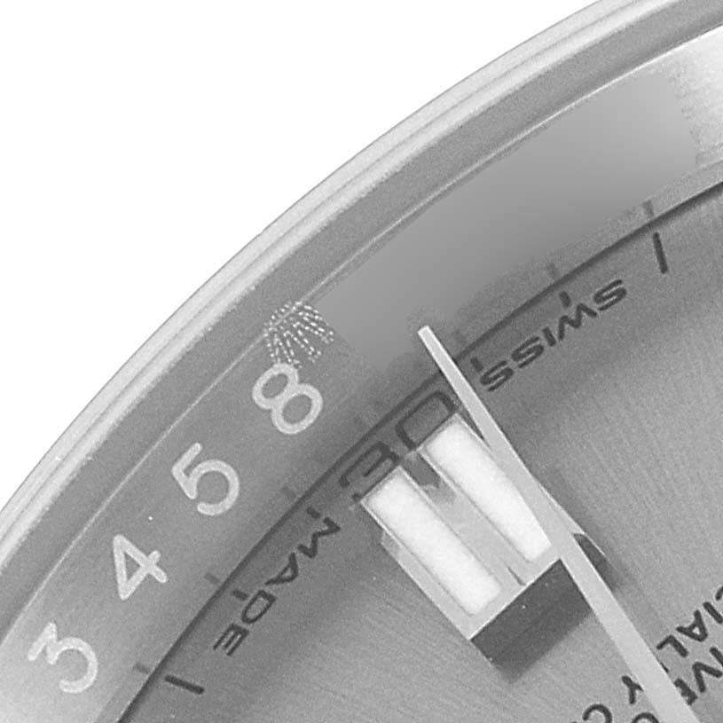 The image shows a close-up of the dial and hands of a Rolex Oyster Perpetual 116000 Men's Stainless Steel Grey Dial 116000 Men's Stainless Steel Grey Dial watch, focusing on the "Swiss Made" label and numerals.