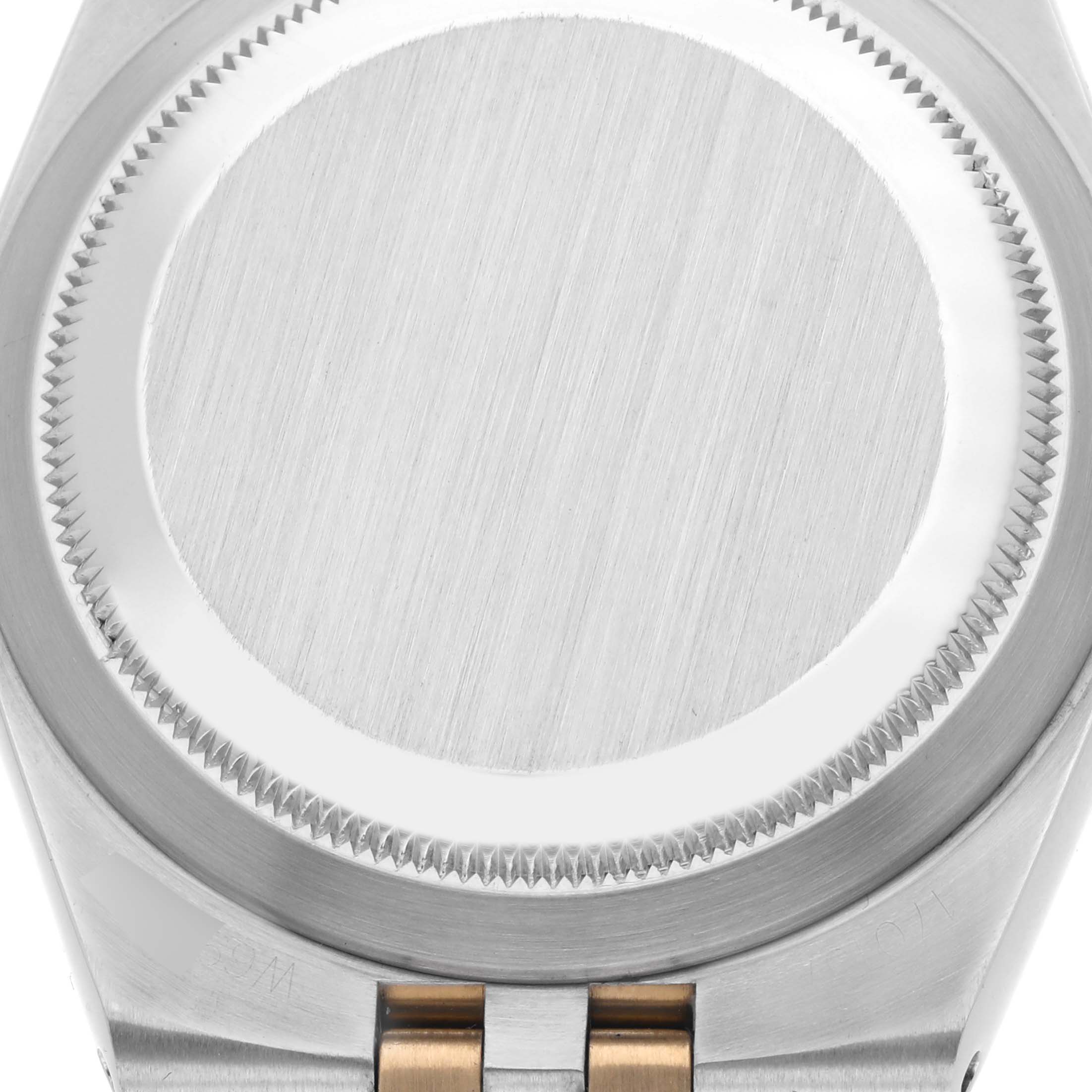 The image shows the back case and part of the bracelet of the Rolex Oysterquartz 17013 Men
s Steel and Gold (two tone) Silver Dial 17013 Men
s Steel and Gold (two tone) Silver Dial watch from a top-down angle.