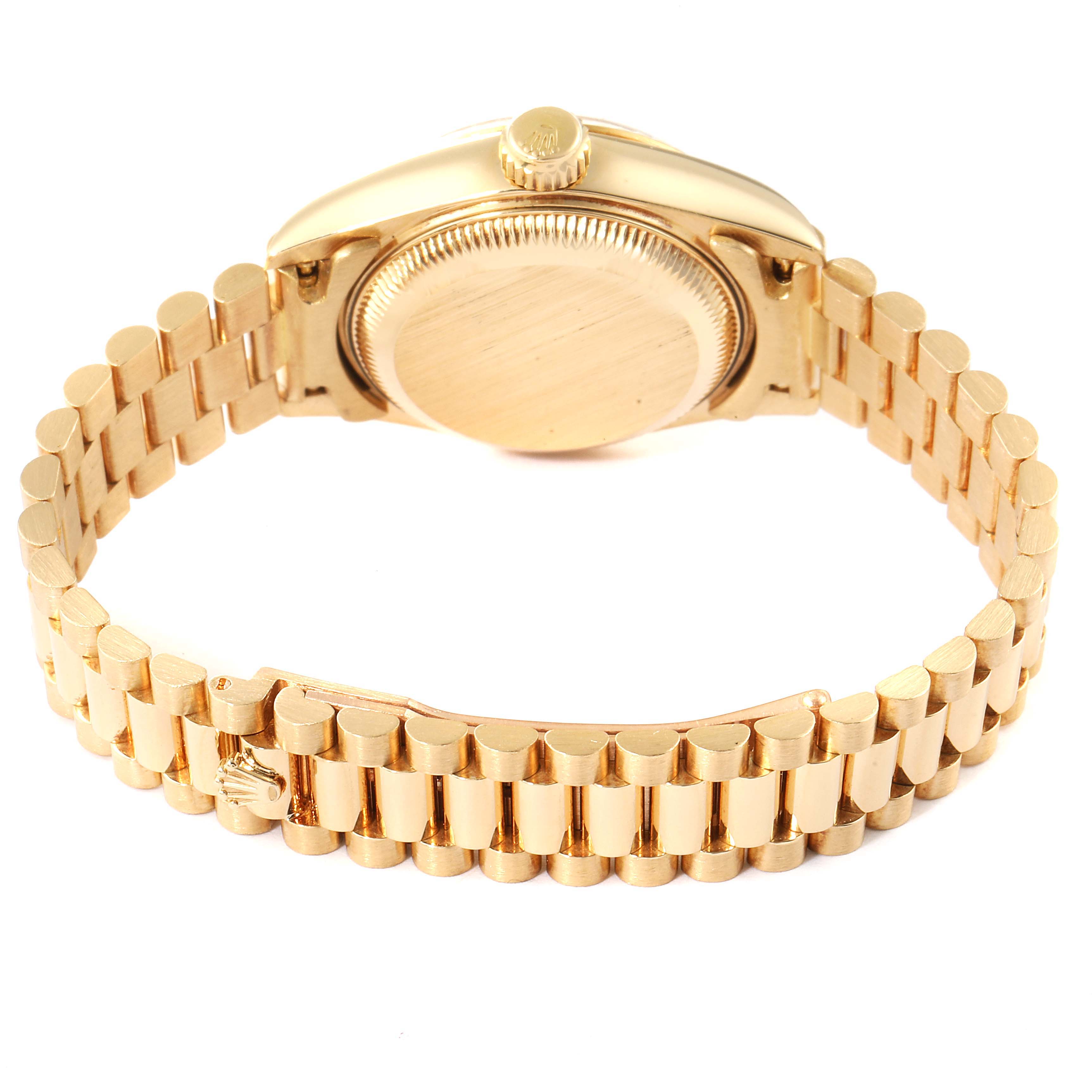 This image shows the back case and bracelet of a Rolex President 69178 Women
s Yellow Gold Champagne Dial 69178 Women
s Yellow Gold Champagne Dial model watch viewed from an angle that highlights the clasp and links.