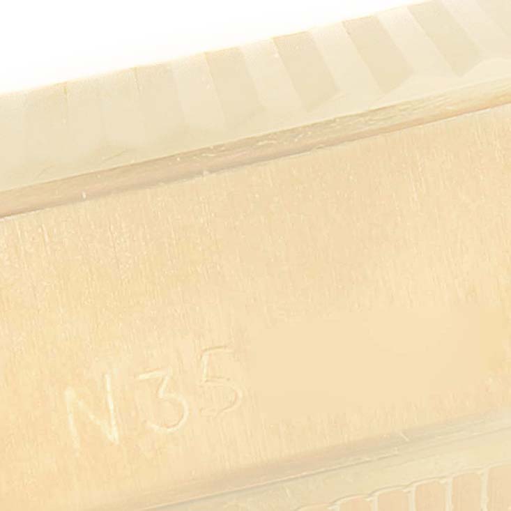 This close-up image shows a detailed view of the side of the case with engravings on a Rolex President 69178 Women
s Yellow Gold Champagne Dial 69178 Women
s Yellow Gold Champagne Dial model watch.