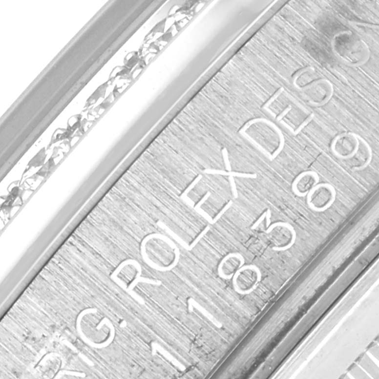 The image shows a close-up of the inner bezel with engravings of a Rolex President 118389 Men's White Gold Silver Dial 118389 Men's White Gold Silver Dial model.
