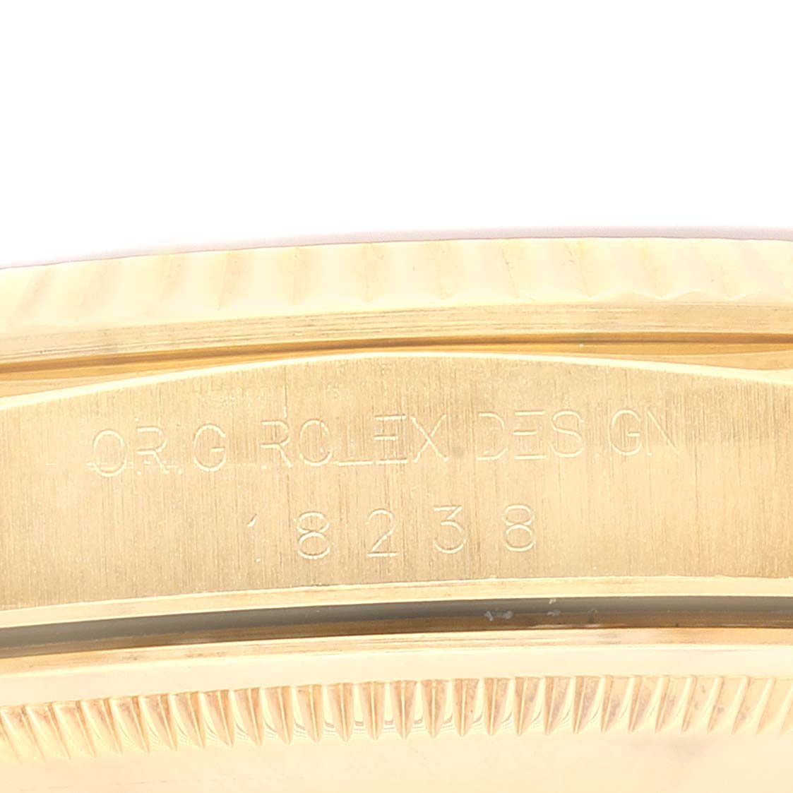 This image shows the side view of the bezel and engraved part of the Rolex President 18238 Men
s Yellow Gold Champagne Dial 18238 Men
s Yellow Gold Champagne Dial watch, model 18238.