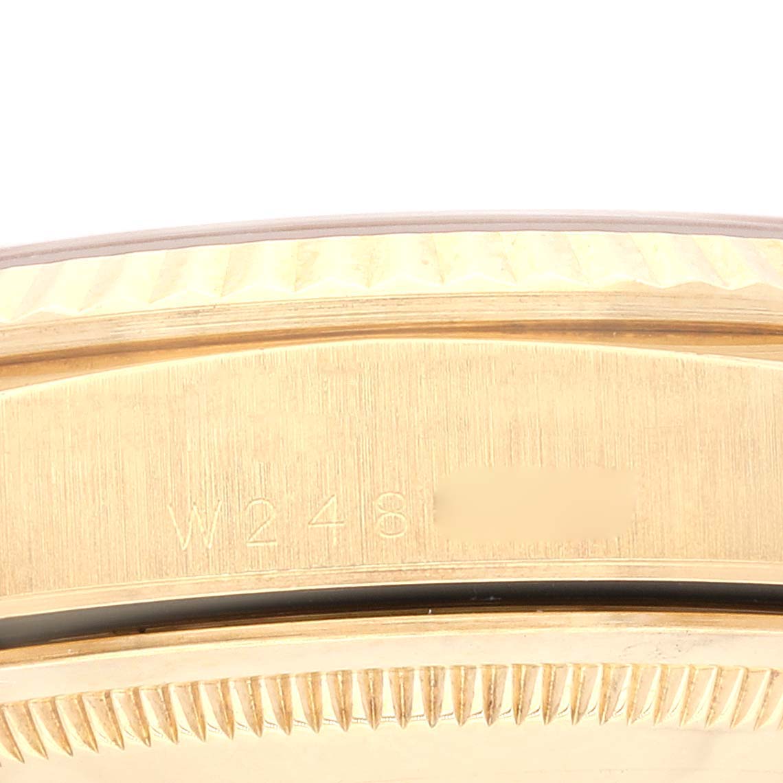 This close-up image shows the side of the Rolex President 18238 Men
s Yellow Gold Champagne Dial 18238 Men
s Yellow Gold Champagne Dial watch bezel and case with engravings.