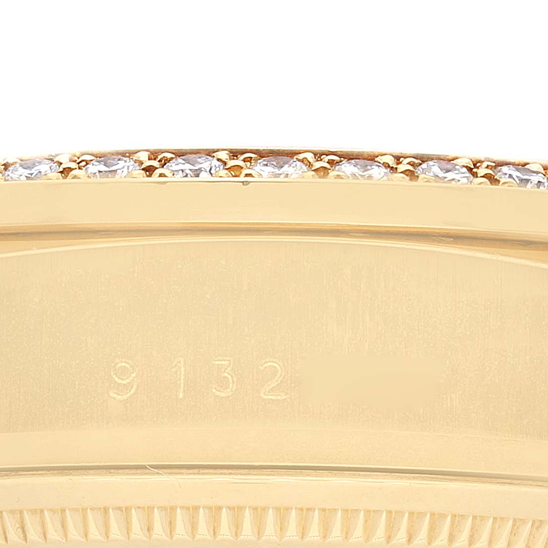 This image shows a close-up of the bezel and part of the case of a Rolex President 18048 Men
s Yellow Gold Champagne Dial 18048 Men
s Yellow Gold Champagne Dial model watch, with diamonds embedded along the edge.
