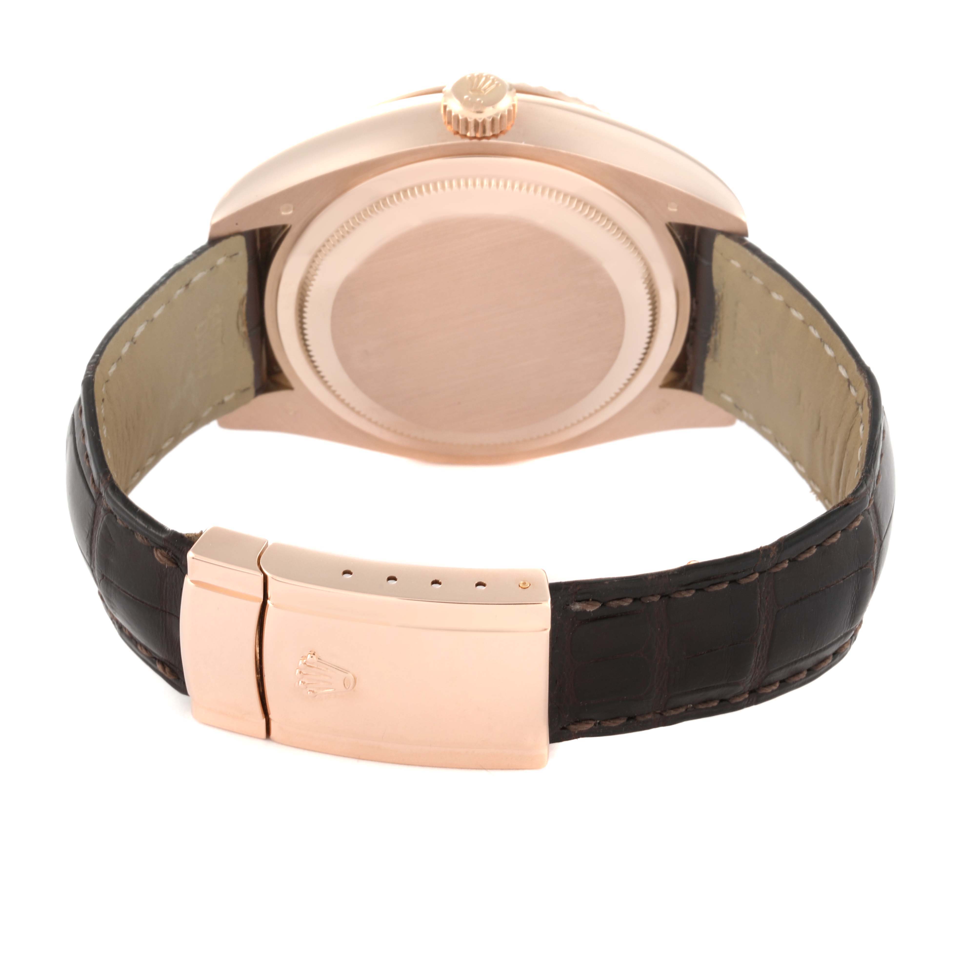 The image shows the back view of a Rolex Sky-Dweller 326135 Men's Rose Gold Brown Dial 326135 Men's Rose Gold Brown Dial watch, highlighting its case, crown, and leather strap with a clasp.