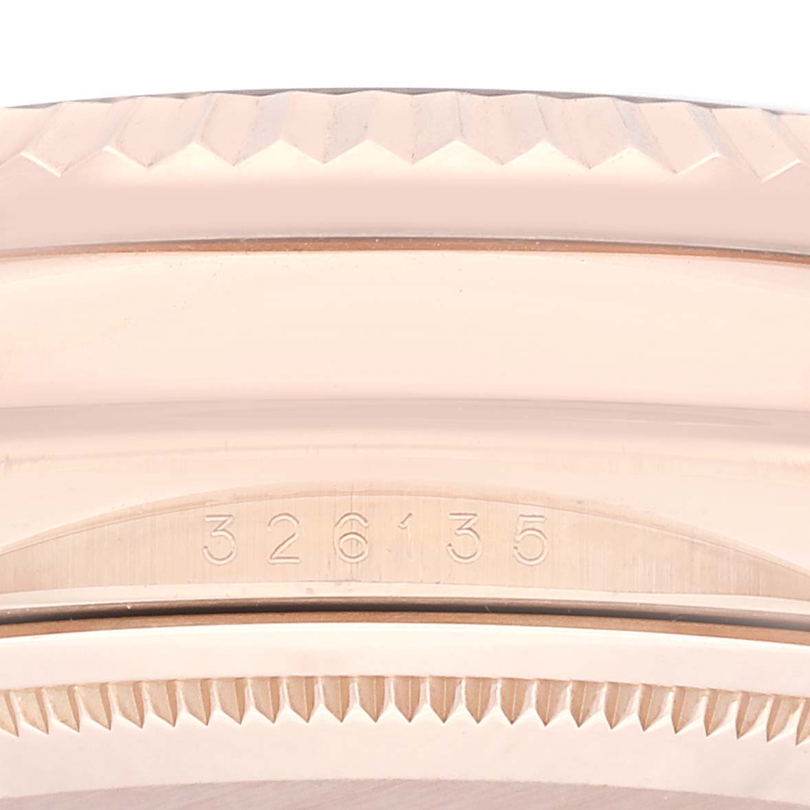 The image shows a close-up of the edge and part of the bezel with a serial number on a Rolex Sky-Dweller 326135 Men's Rose Gold Brown Dial 326135 Men's Rose Gold Brown Dial watch.