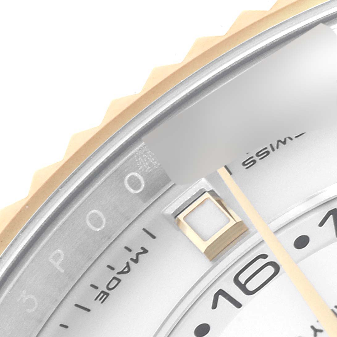 The image shows a close-up view of the bezel, dial, and part of the date indicator on a Rolex Sky-Dweller 326933 Men's Steel and Gold (two tone) White Dial 326933 Men's Steel and Gold (two tone) White Dial watch.