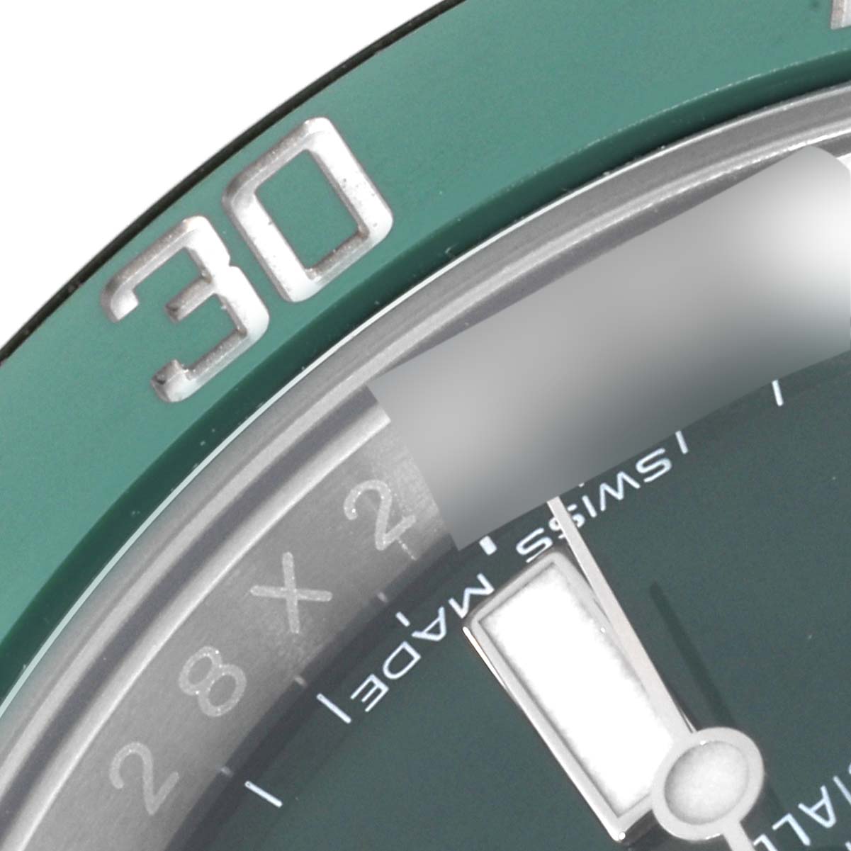 The image shows a close-up view of the bezel and part of the dial of a Rolex Submariner 116610LV Men's Stainless Steel Green Dial 116610LV Men's Stainless Steel Green Dial, focusing on the "30" minute mark.