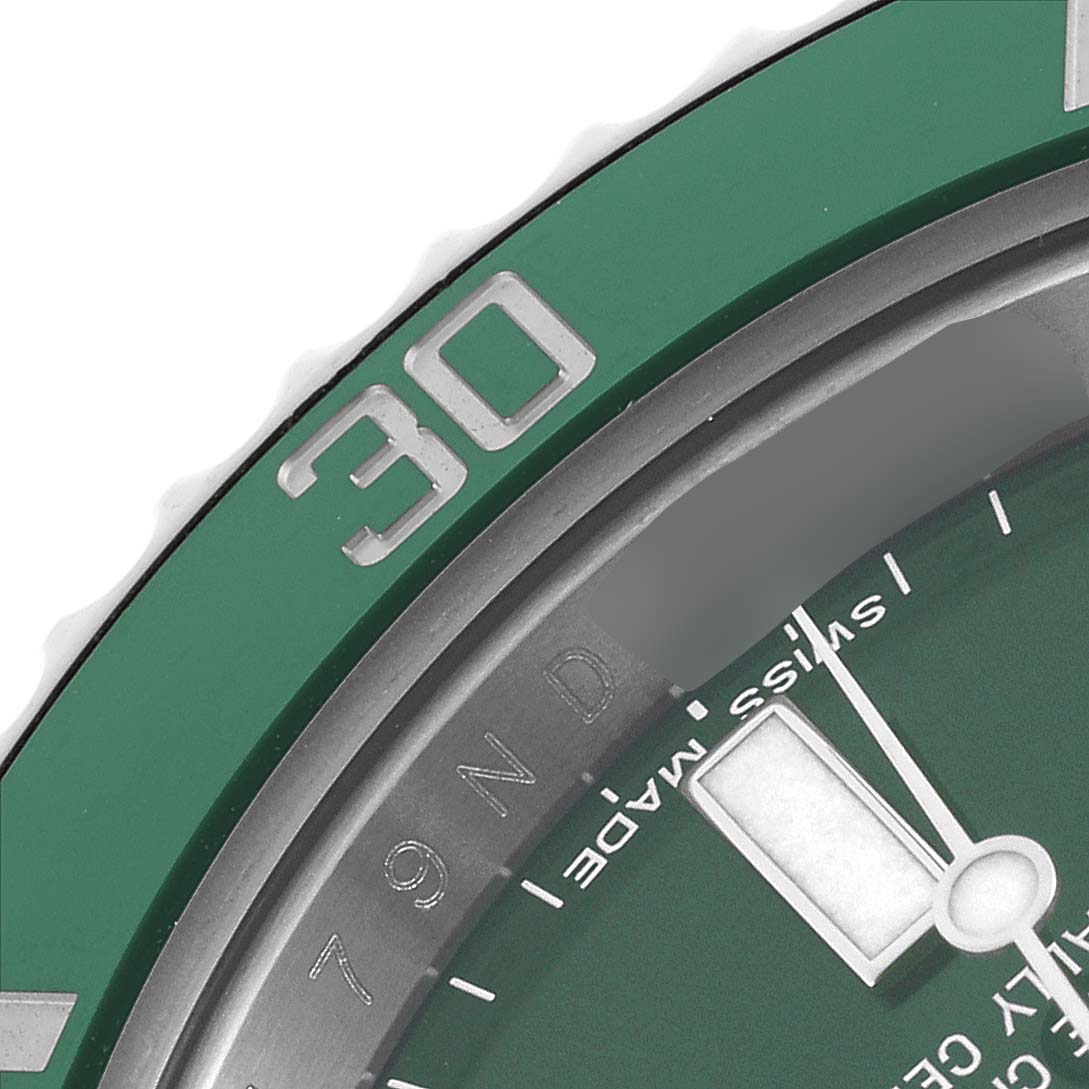 The image shows a close-up angle of the Rolex Submariner 116610LV Men
s Stainless Steel Green Dial 116610LV Men
s Stainless Steel Green Dial
s green bezel and part of the dial with the minute hand.