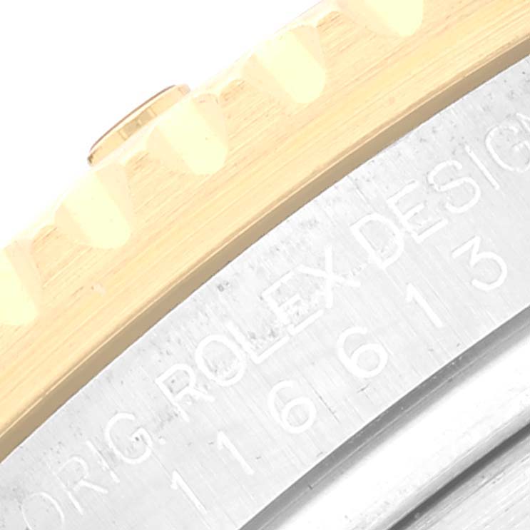The image shows a close-up of the bezel and part of the casing with engraving on a Rolex Submariner 116613 Men's Steel and Gold (two tone) Black Dial 116613 Men's Steel and Gold (two tone) Black Dial watch.