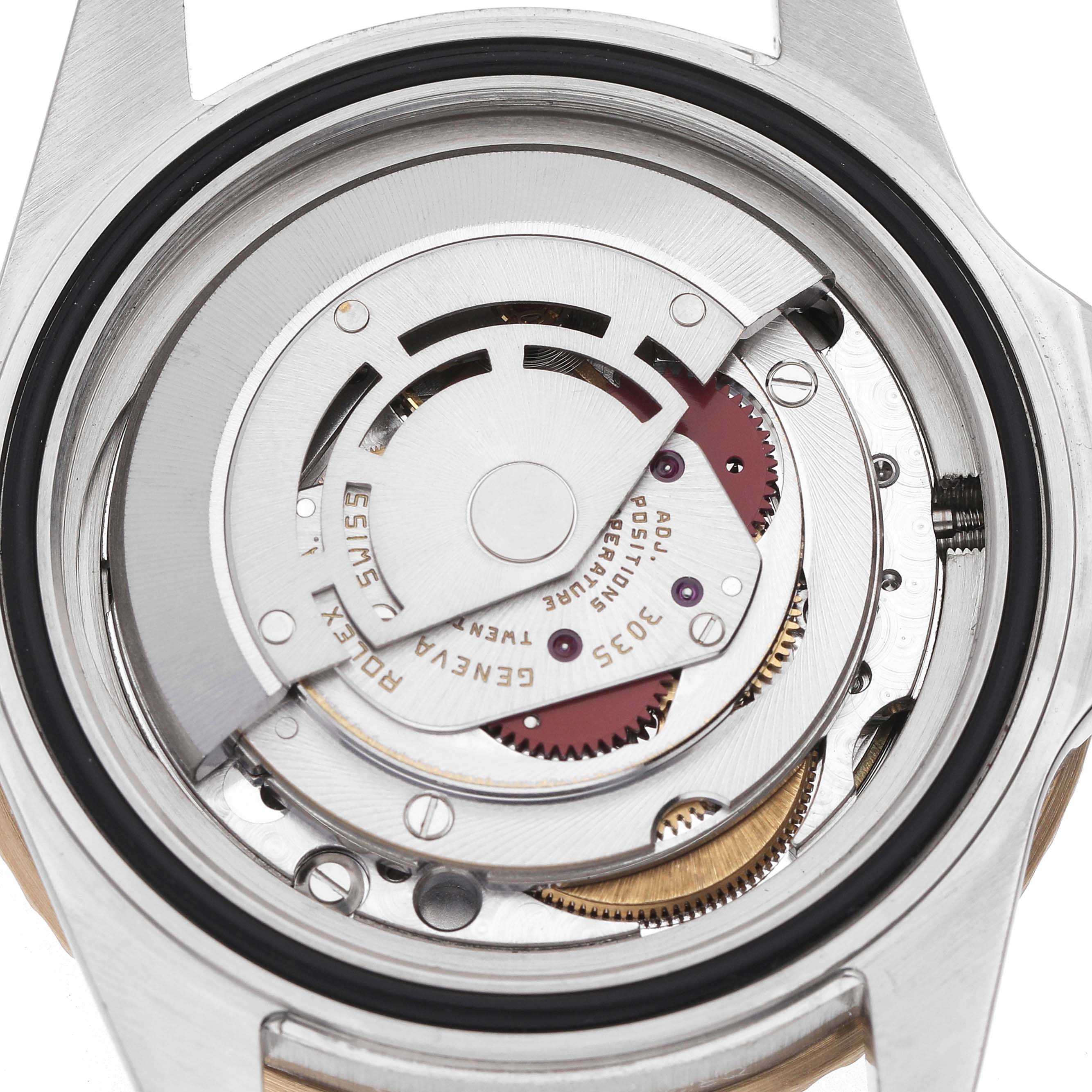 The image shows the movement mechanism of a Rolex Submariner 16803 Men's Steel and Gold (two tone) Black Dial watch from a back view, highlighting its intricate components.