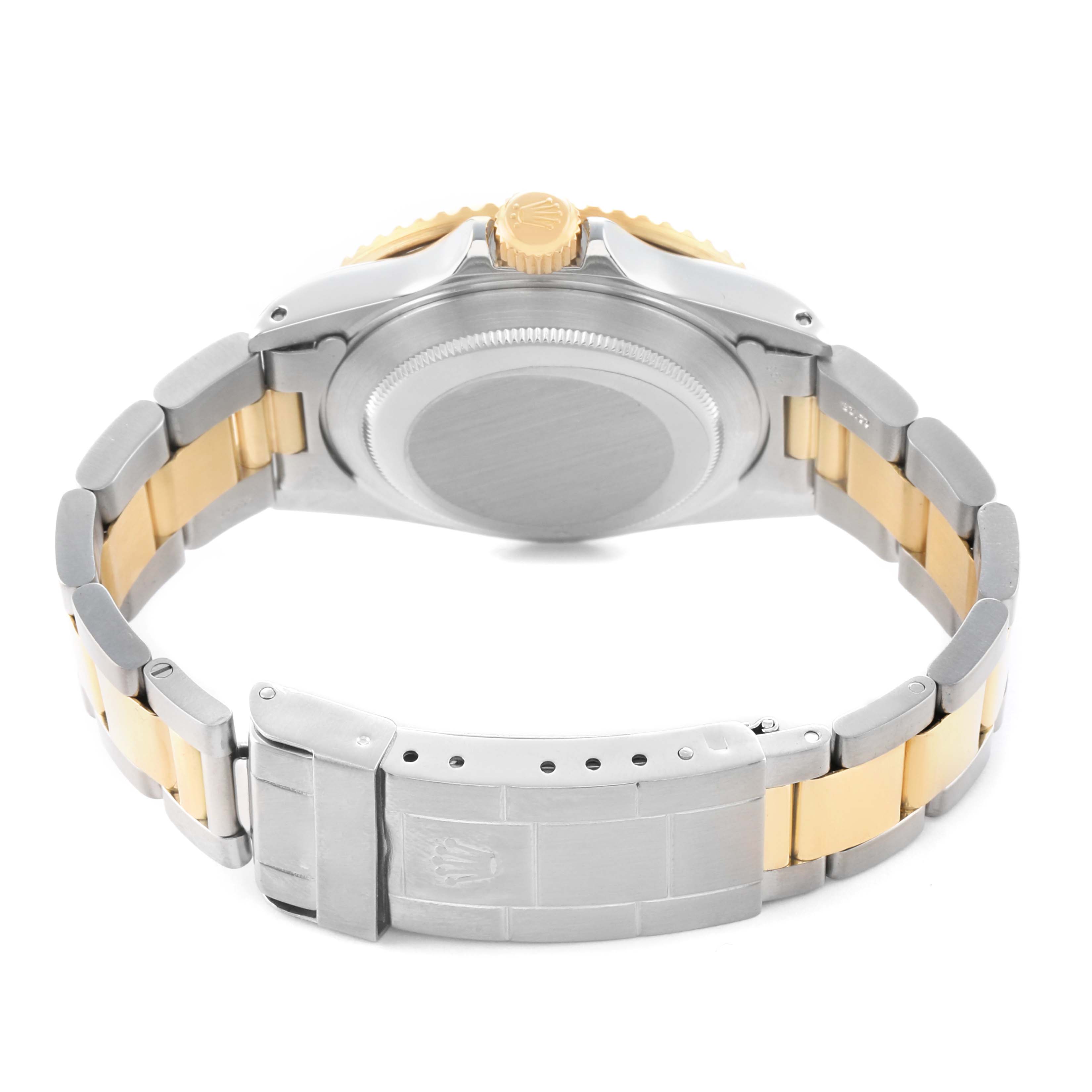 The image shows the back of a Rolex Submariner 16803 Men's Steel and Gold (two tone) Black Dial, highlighting the case back, crown, and bracelet clasp.