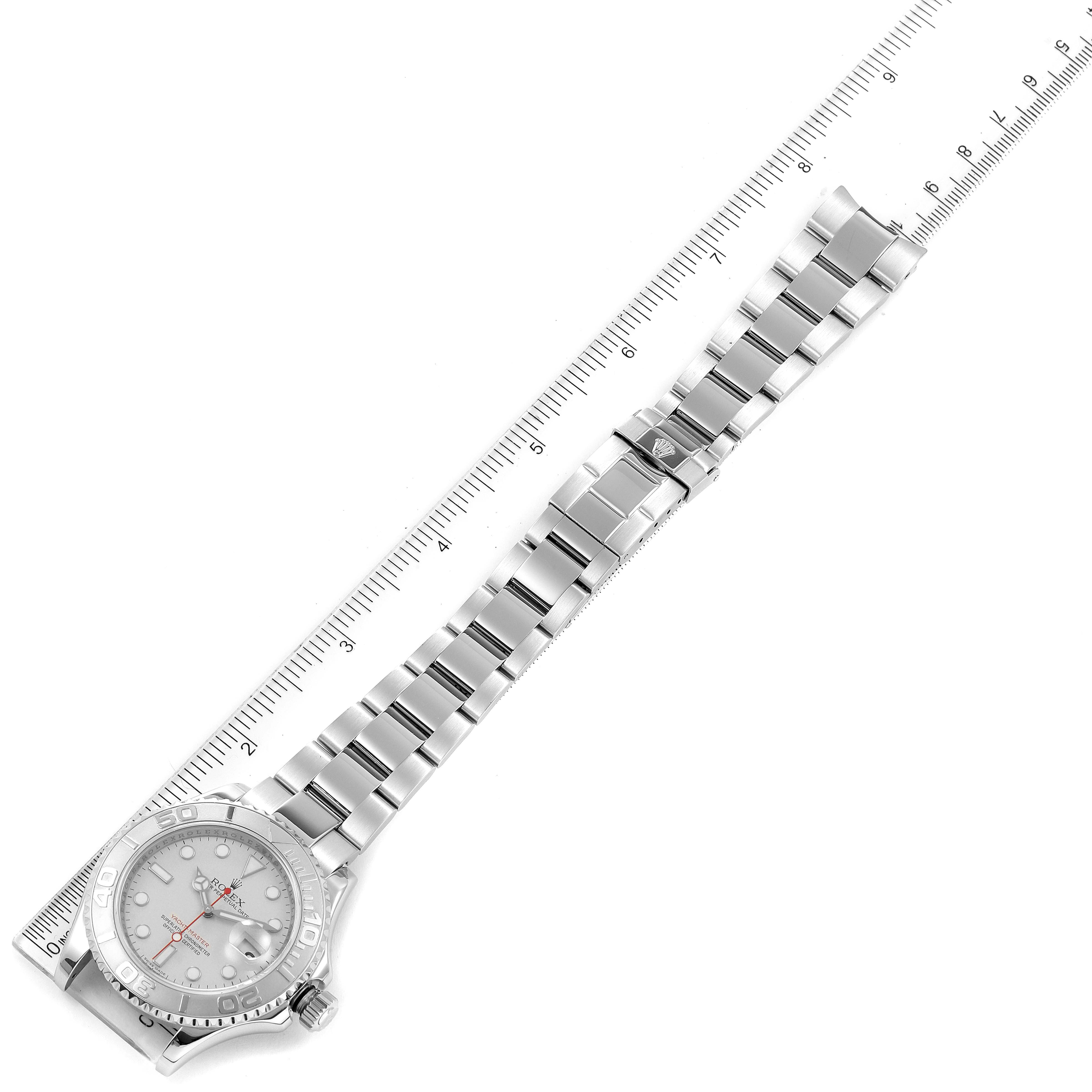 The image shows a Rolex Yacht-Master 16622 Men's Stainless Steel Silver Dial 16622 Men's Stainless Steel Silver Dial watch laid flat alongside a ruler, highlighting the case, bracelet, and clasp.