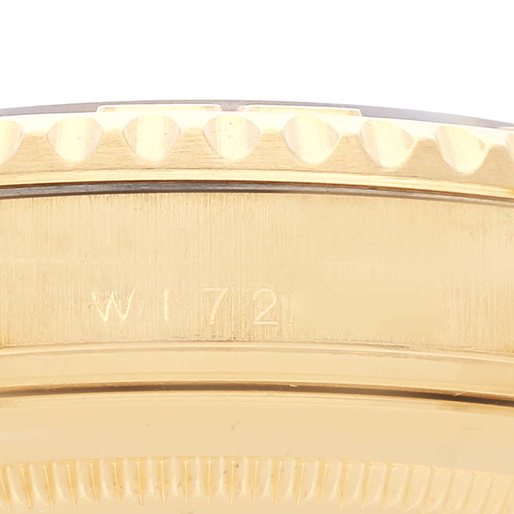 This close-up image shows the engraved serial number on the side and the textured bezel of a Rolex Yacht-Master 16628 Men's Yellow Gold Blue Dial 16628 Men's Yellow Gold Blue Dial watch.