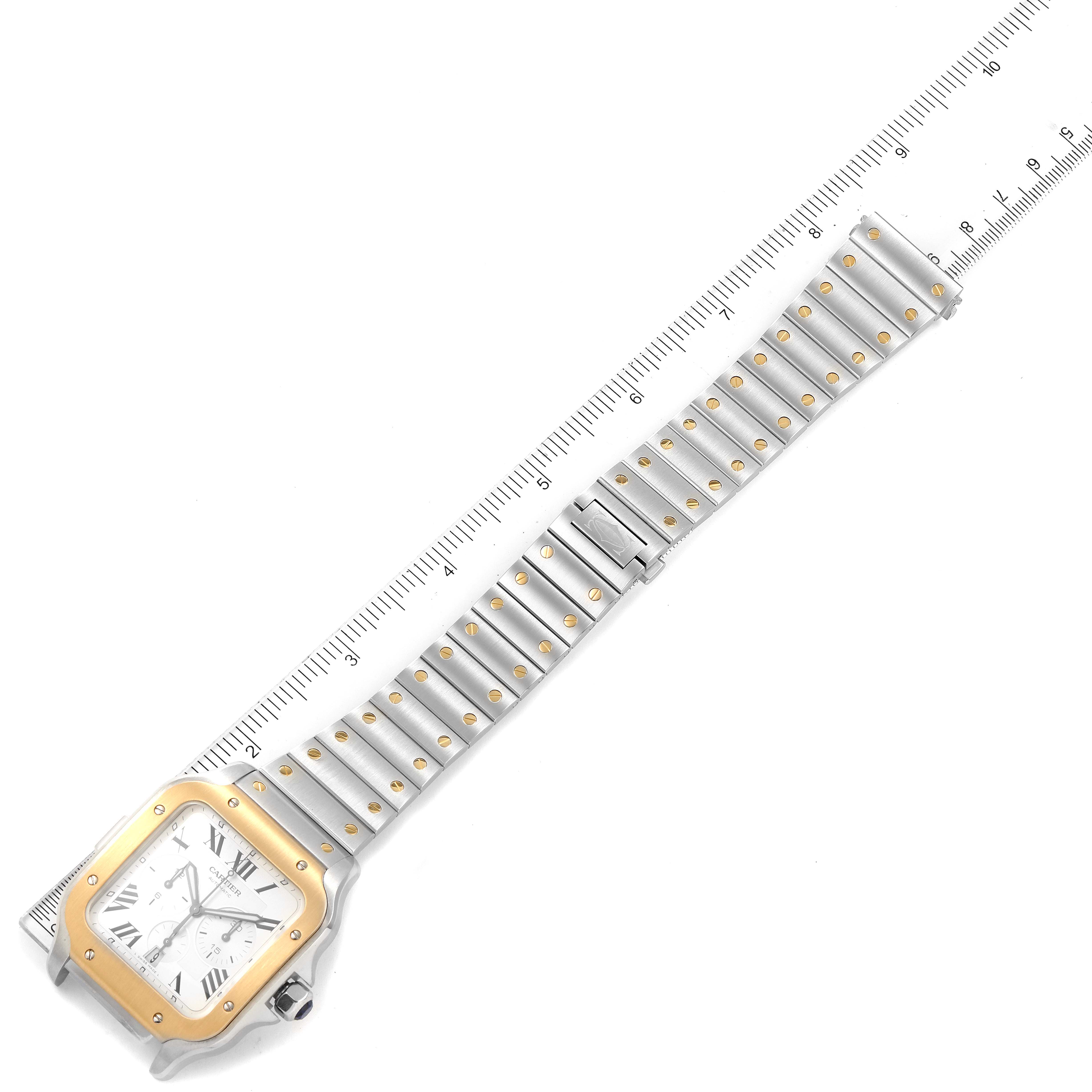 The image shows a top-down view of a Santos model watch by Cartier, highlighting its face and metal bracelet with a ruler for scale.