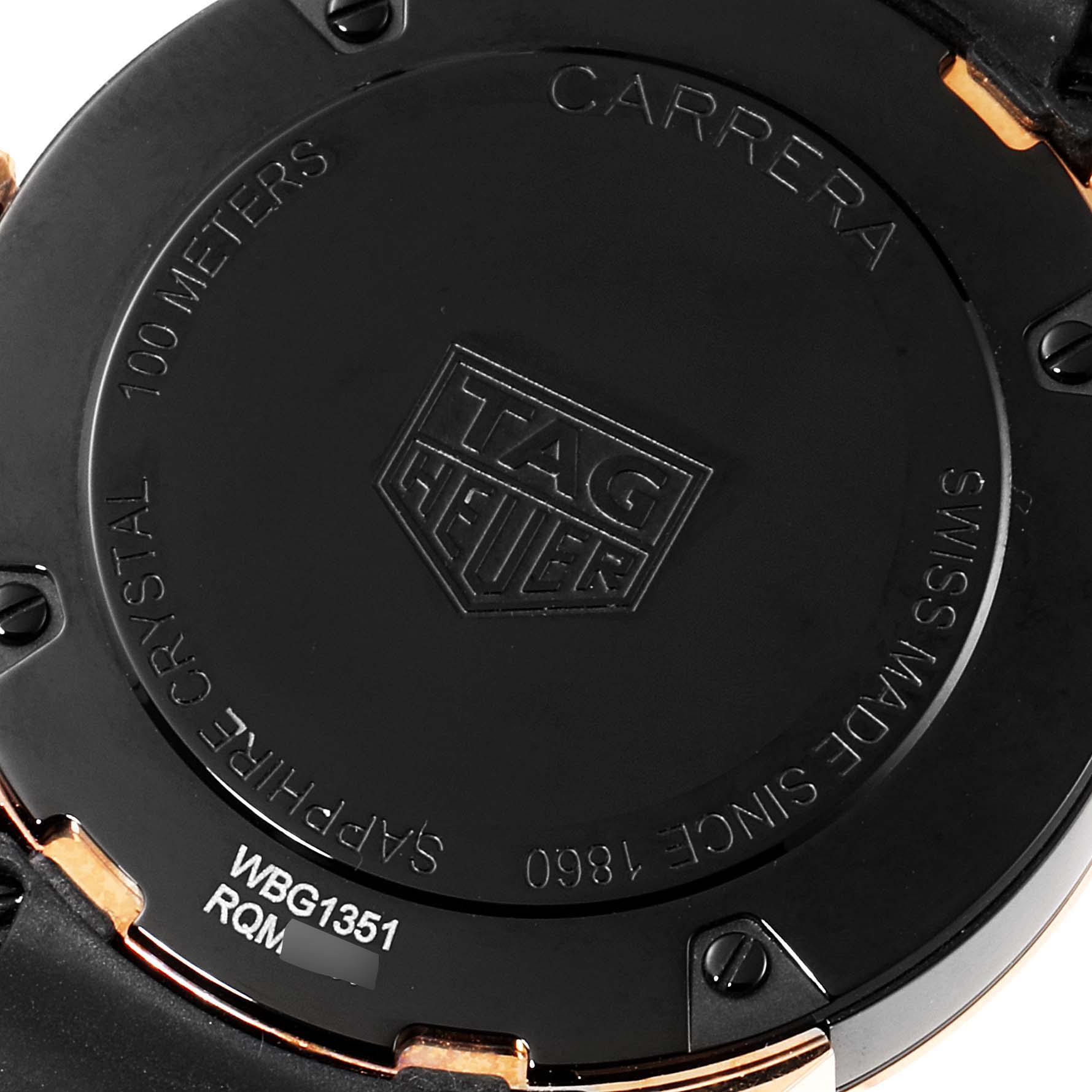 The image shows the back case of a Tag Heuer Carrera WBG1351.FC6418 Women's Steel and Gold (two tone) Black Dial WBG1351.FC6418 Women's Steel and Gold (two tone) Black Dial watch, highlighting engravings and the logo.