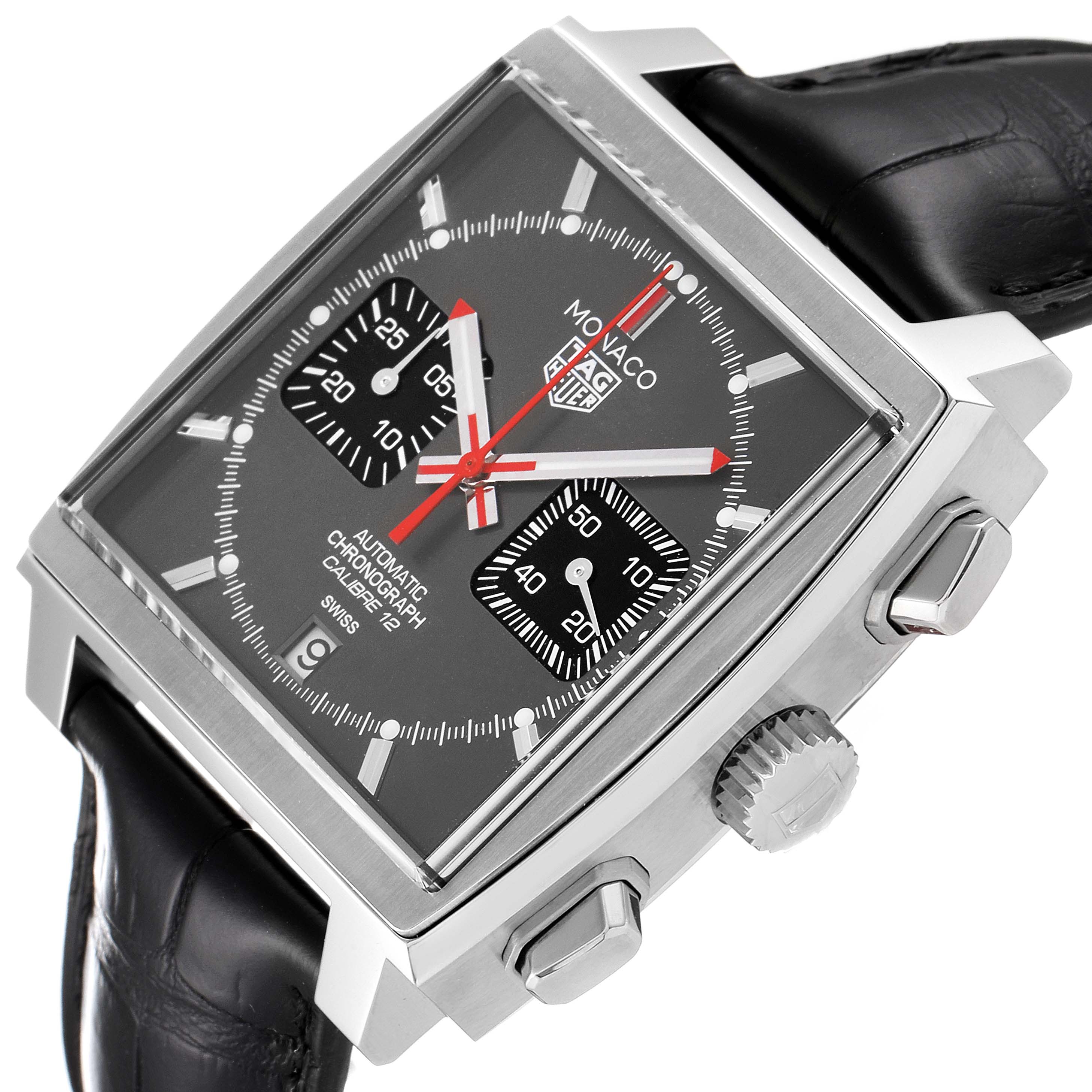 The Tag Heuer Monaco watch is shown from a three-quarter angle highlighting the square face, subdials, crown, and pushers.
