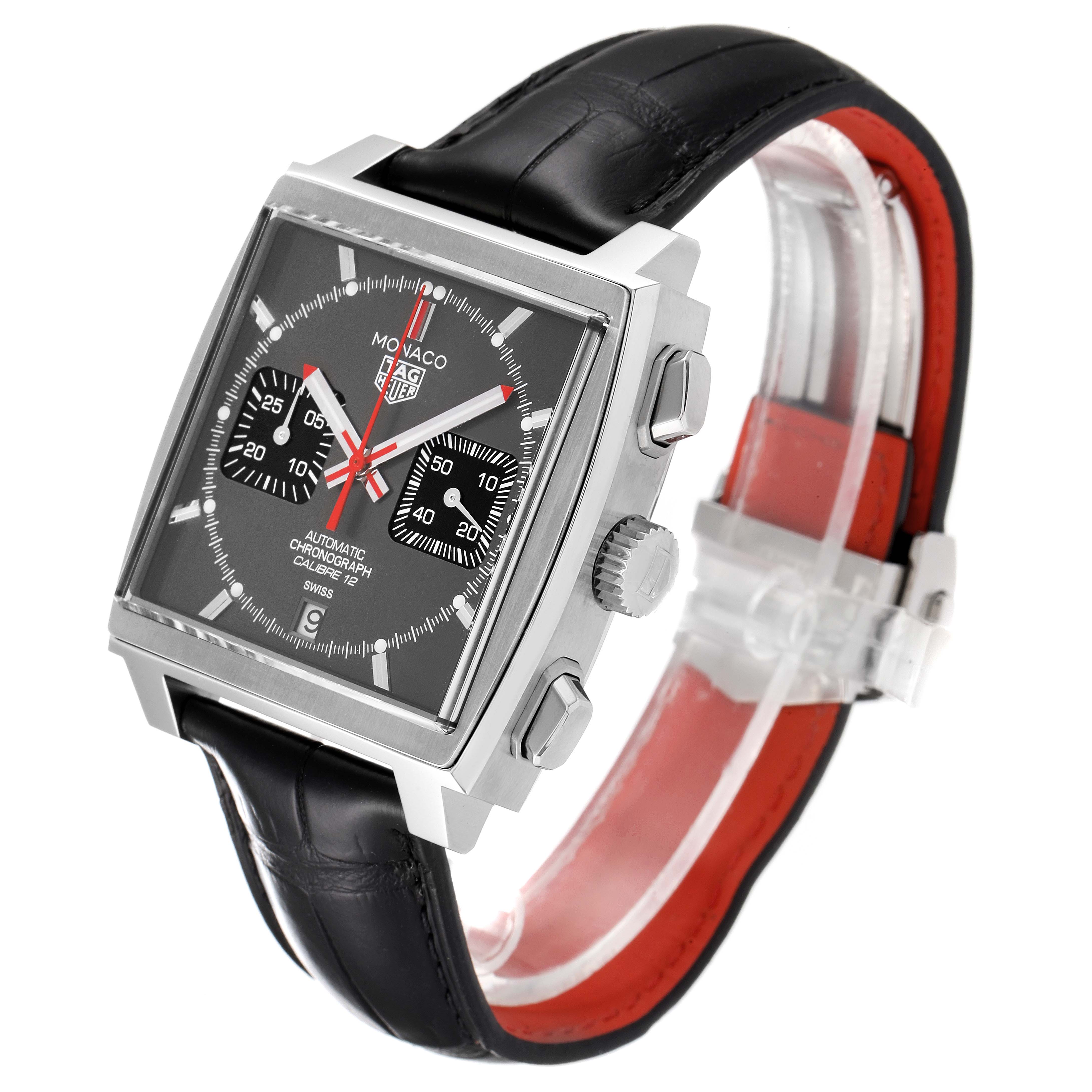 The Tag Heuer Monaco watch is shown at a three-quarter angle, highlighting the face, crown, pushers, and strap.